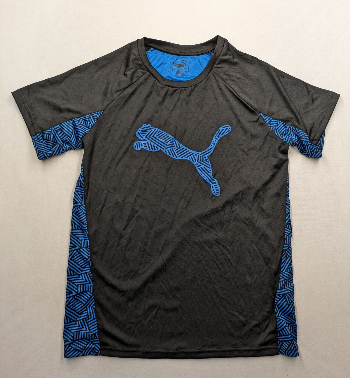 Puma black performance T-shirt with blue geometric side panels and iconic logo.