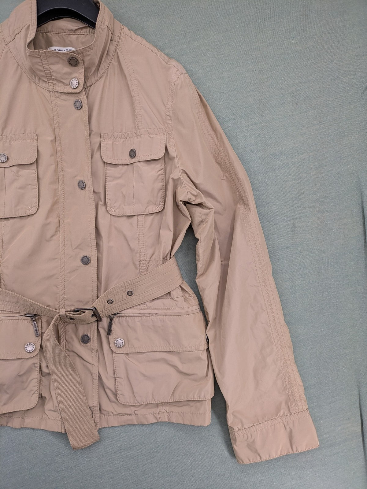 MORE & MORE beige field jacket with belt, four pockets, and standing collar.