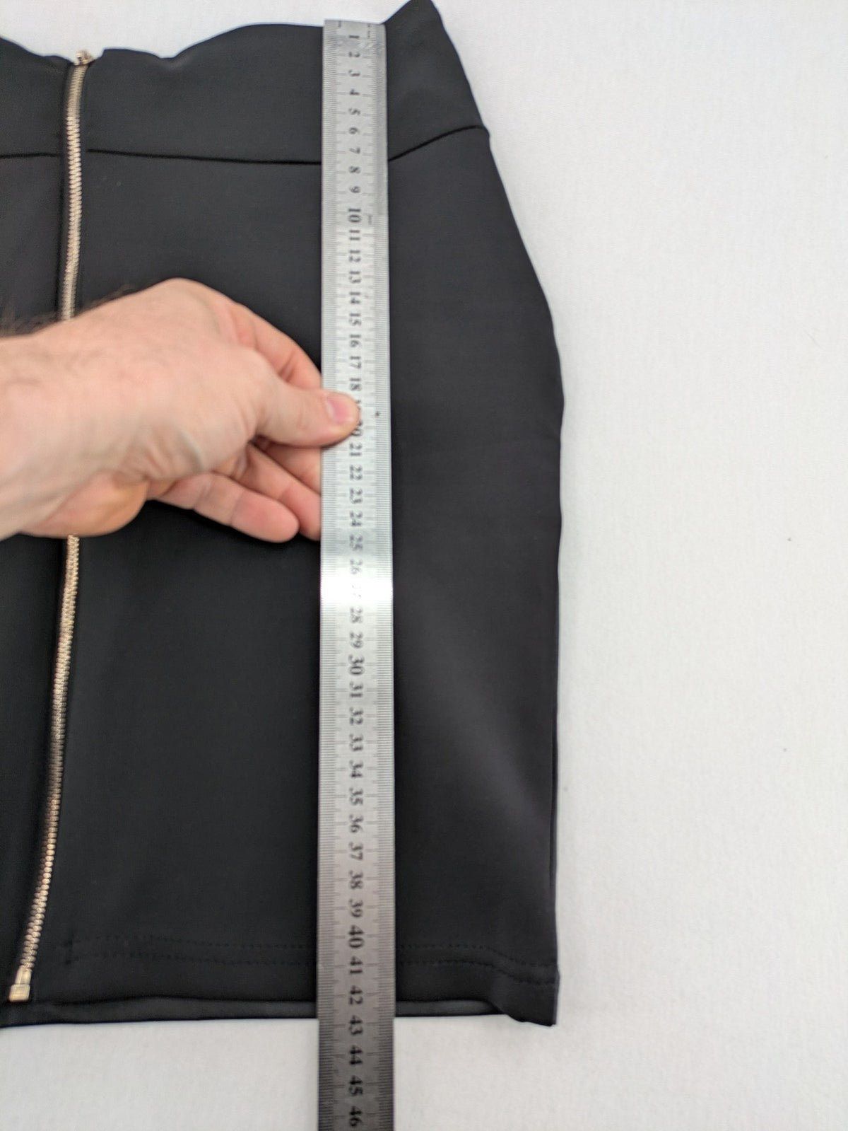 Romatie black mini bodycon skirt satin finish high waist with gold zippers and buckles.