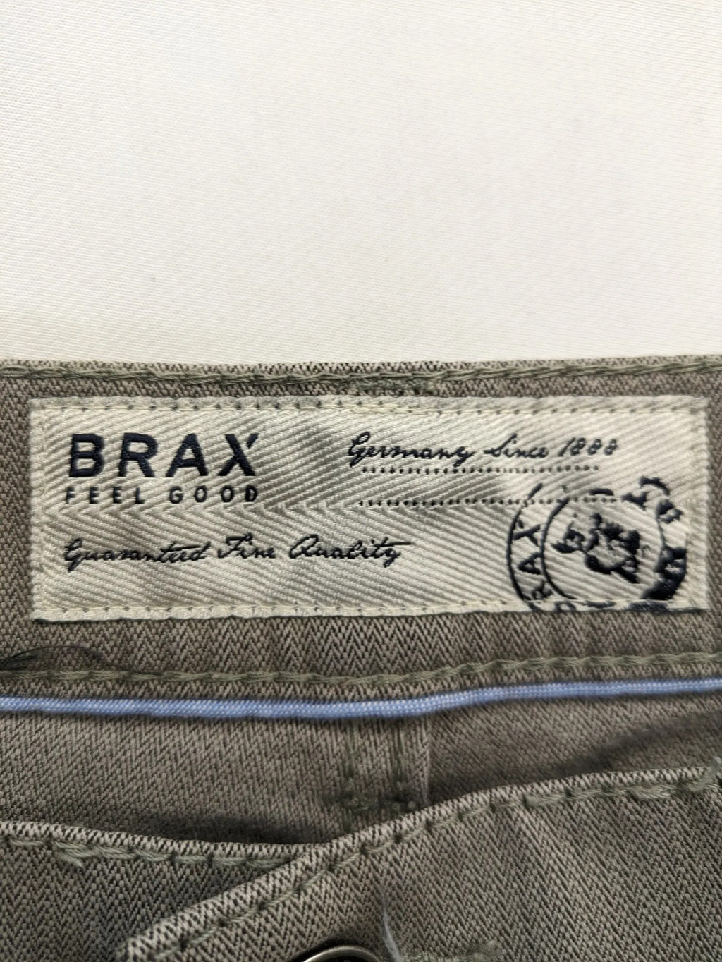 BRAX grey straight jeans 5-pocket design with zipper fly and soft fabric.