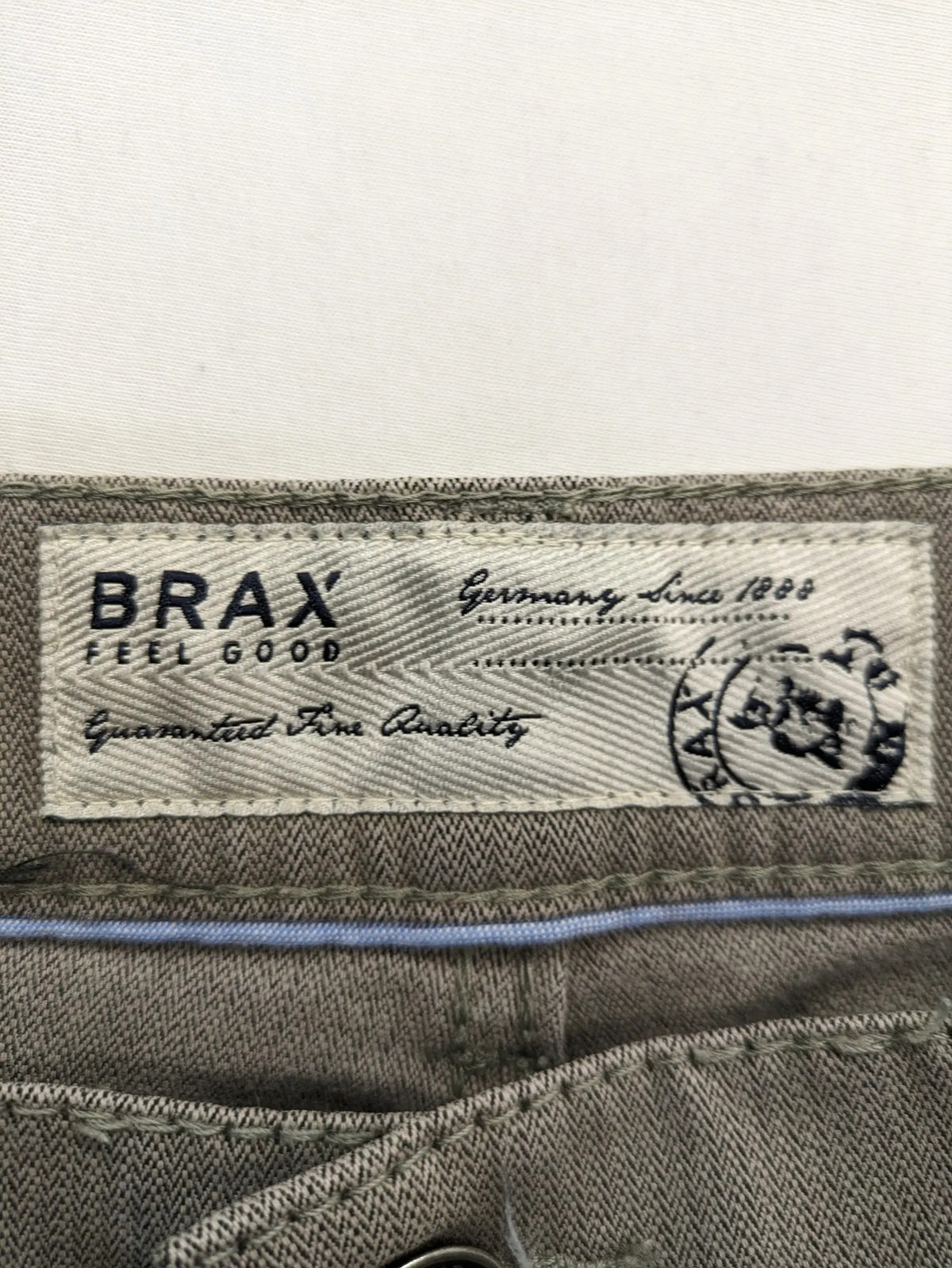 BRAX grey straight jeans 5-pocket design with zipper fly and soft fabric.