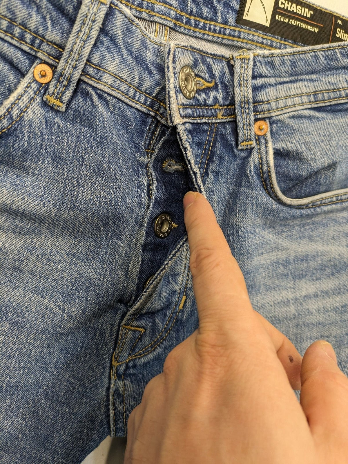 CHASIN' blue slim fit jeans with button fly and classic denim craftsmanship.