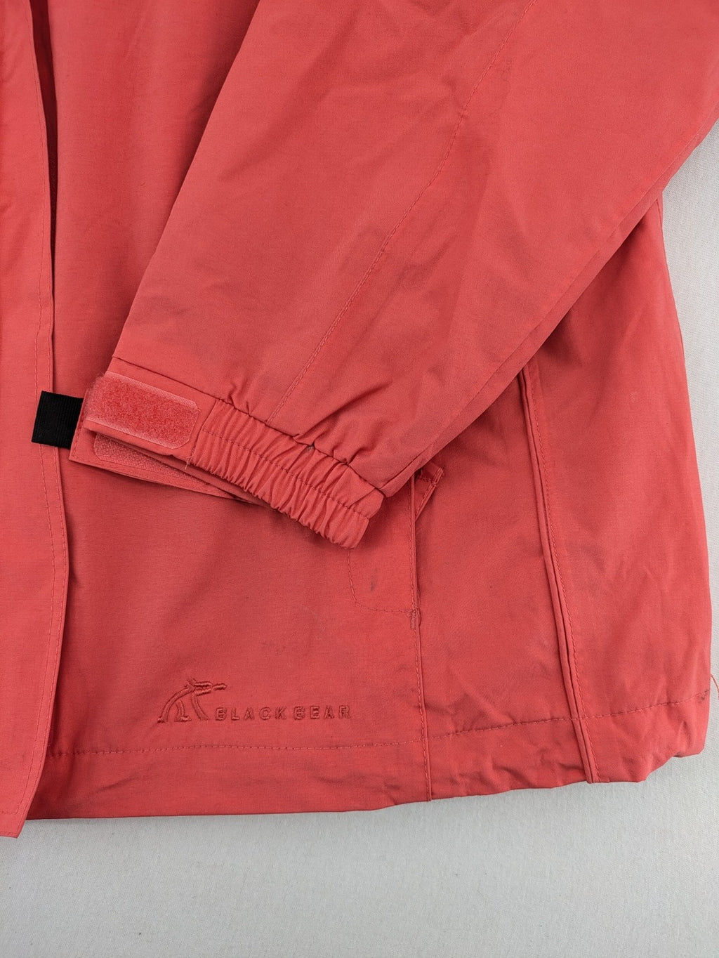 Black Bear black rain jacket with coral pink mesh lining and full zipper.
