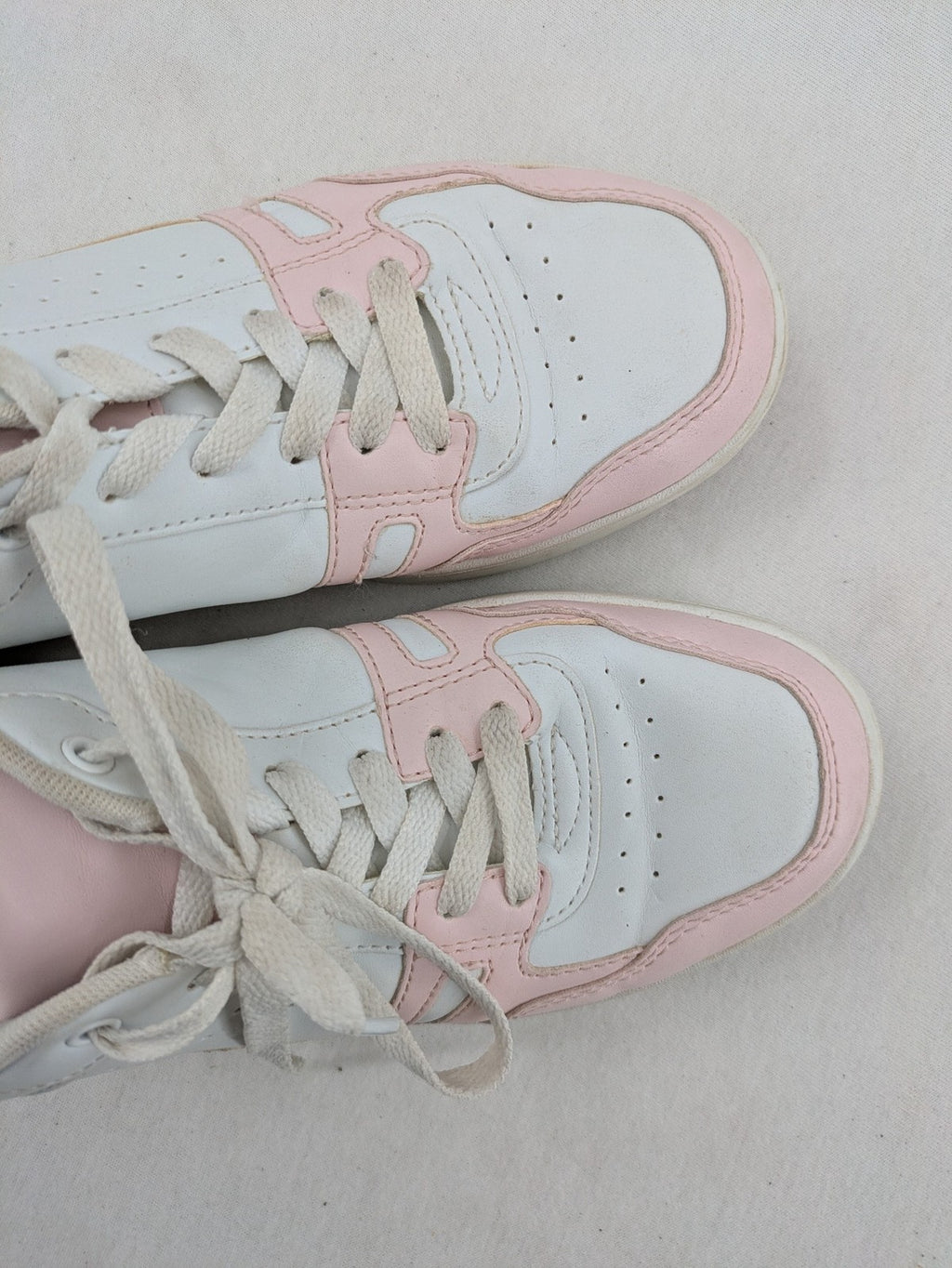 Graceland white sneakers with pink and mint green accents, low-top design, cushioned tongue.