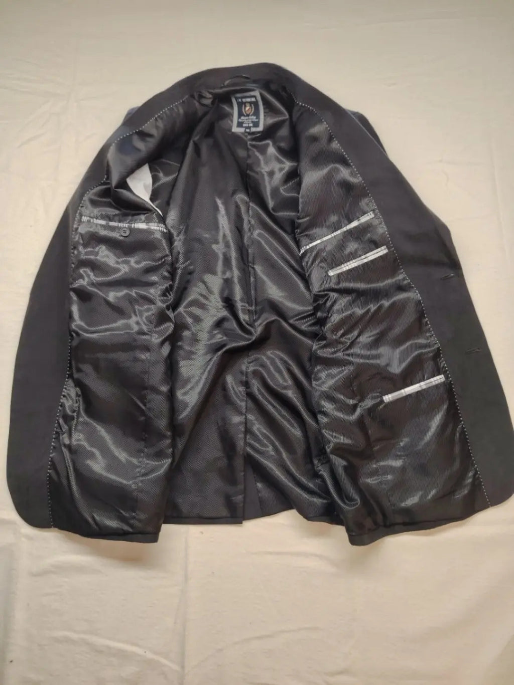 dunmore black blazer two-button design with falling lapels and multiple pockets