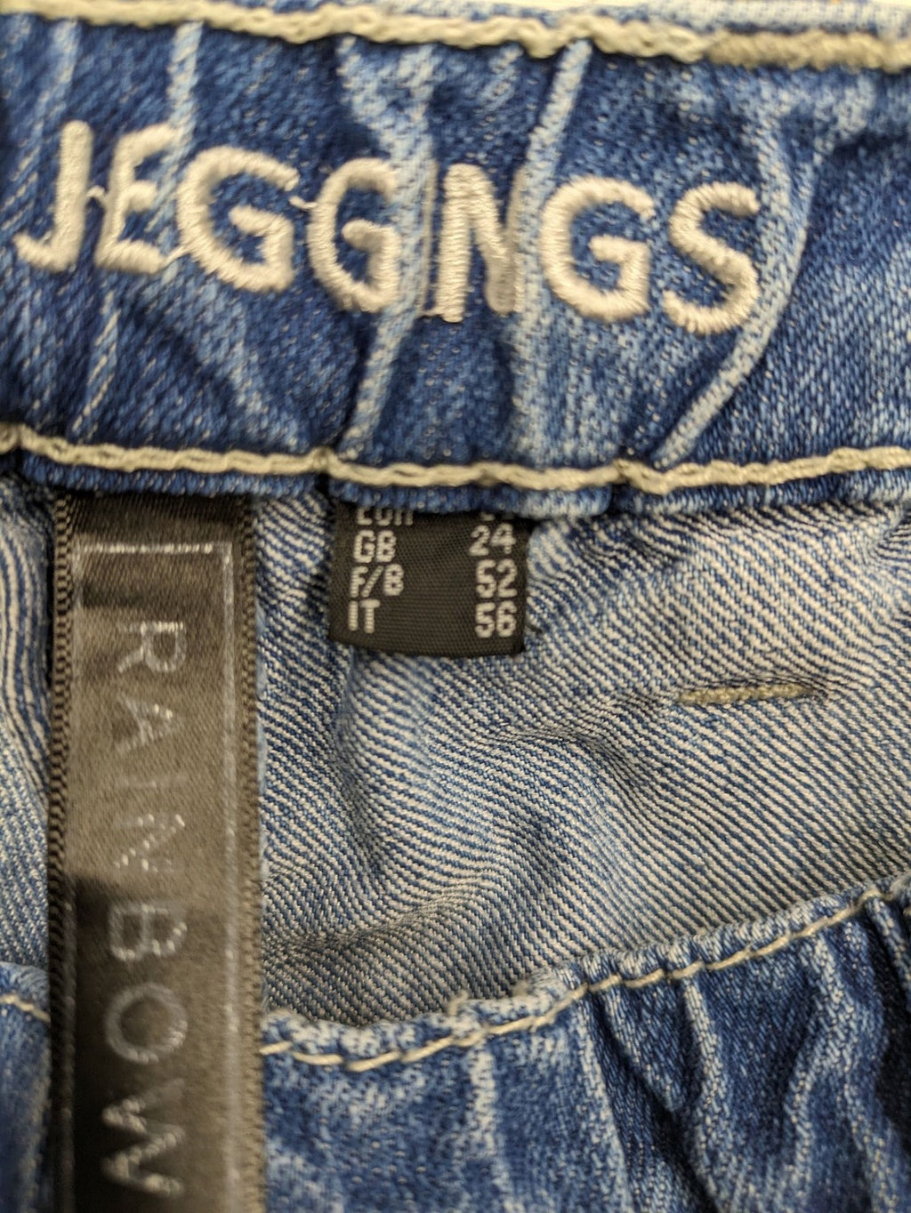 Rainbow blue straight jeans with elastic waistband and decorative knee stitching.