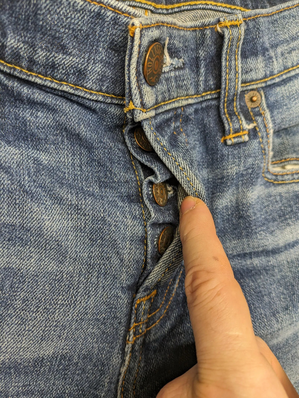 Hollister blue slim fit jeans with distressed detailing and classic button fly.