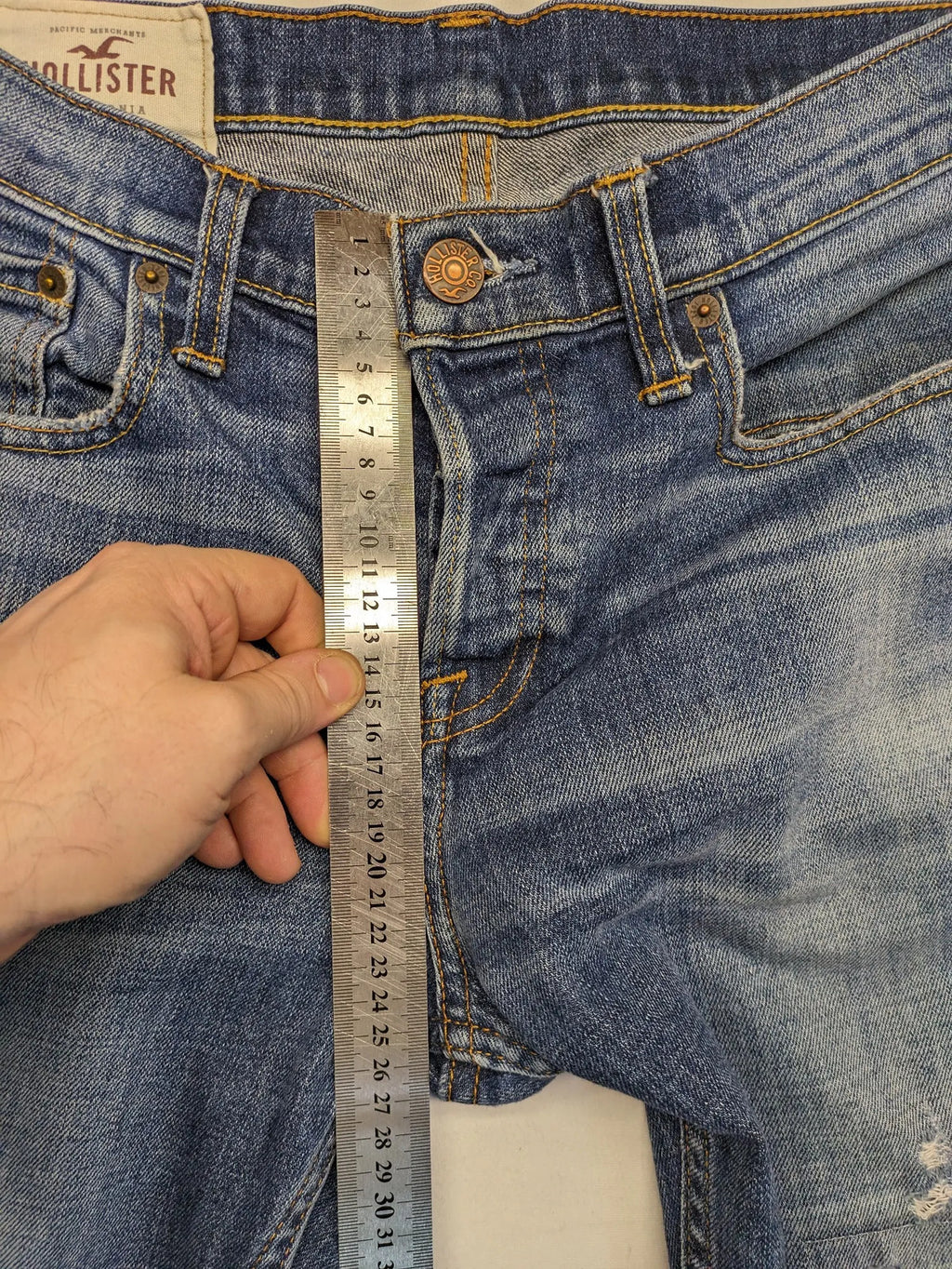 Hollister blue slim fit jeans with distressed detailing and classic button fly.
