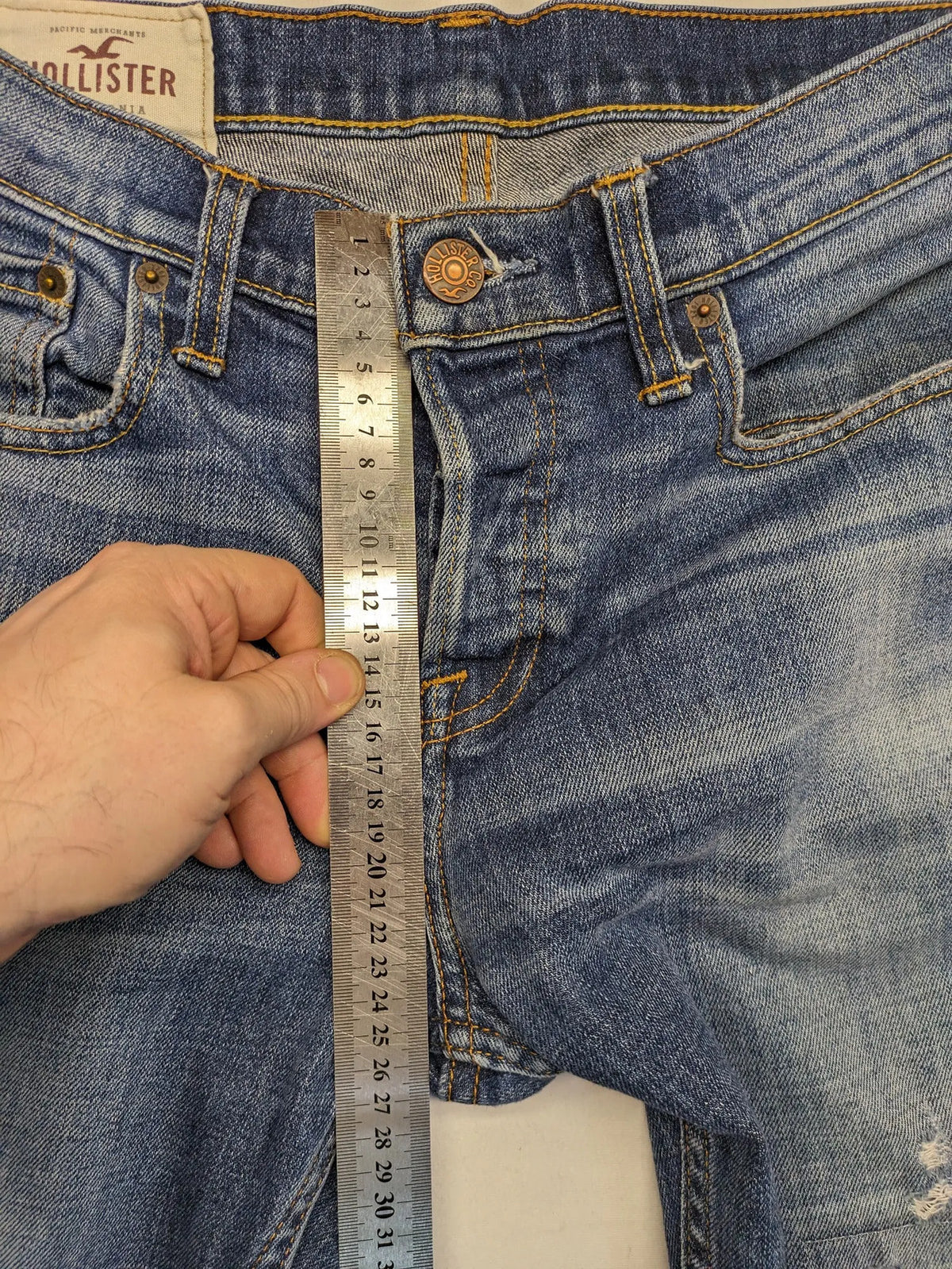 Hollister blue slim fit jeans with distressed detailing and classic button fly.