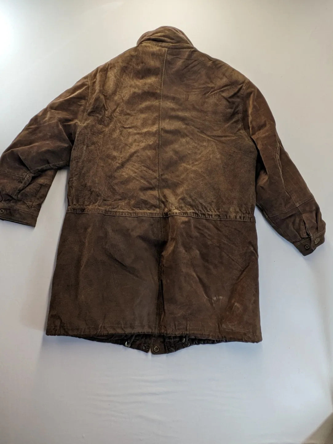 Vintage brown leather jacket with graphic lining, zip closure, and button placket.