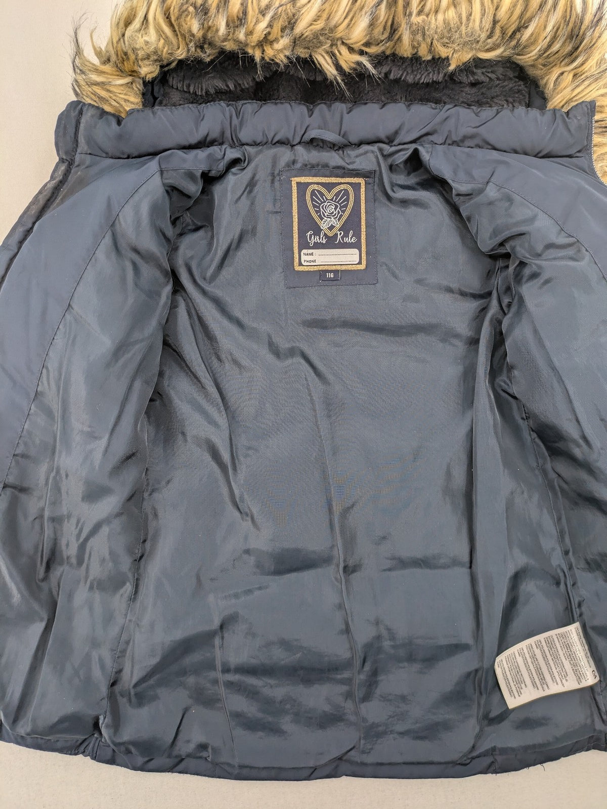 GEF cream coat with quilted design, fleece-lined hood, and faux fur trim.