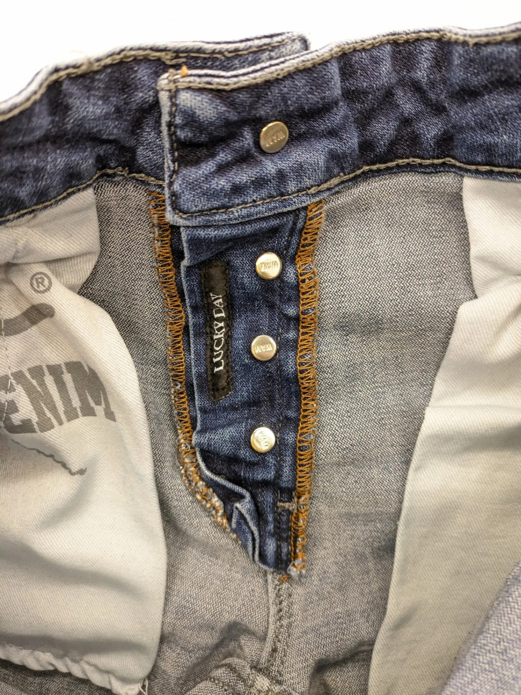WAM Denim blue straight jeans with distressed details and button fly.