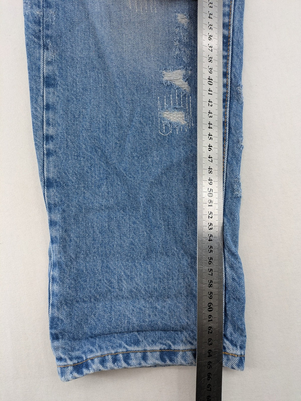 G-Star Raw blue distressed high boyfriend jeans with ripped details and classic button closure.