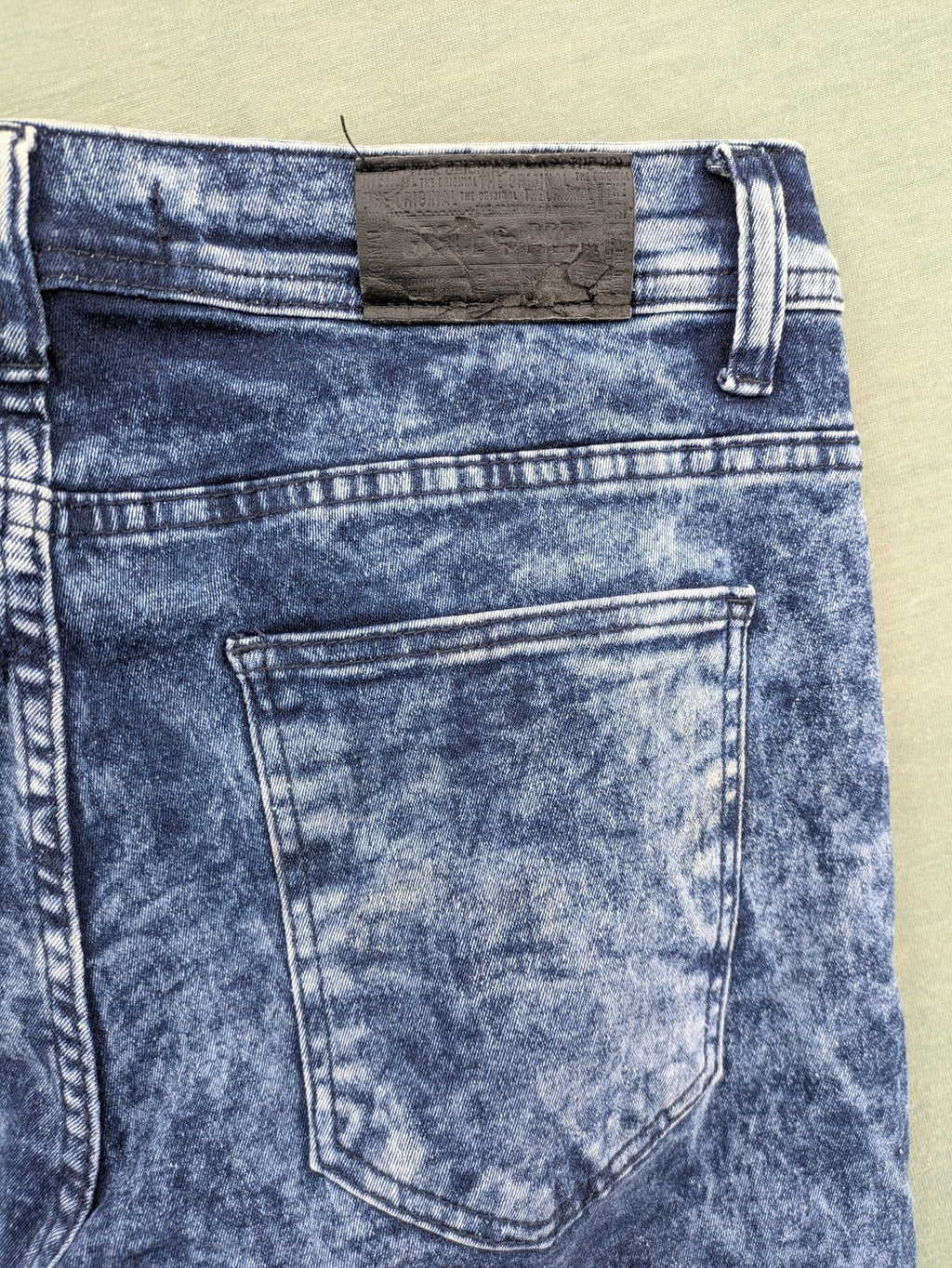 Stark straight jeans multi distressed acid wash with orange patches and side stripes.