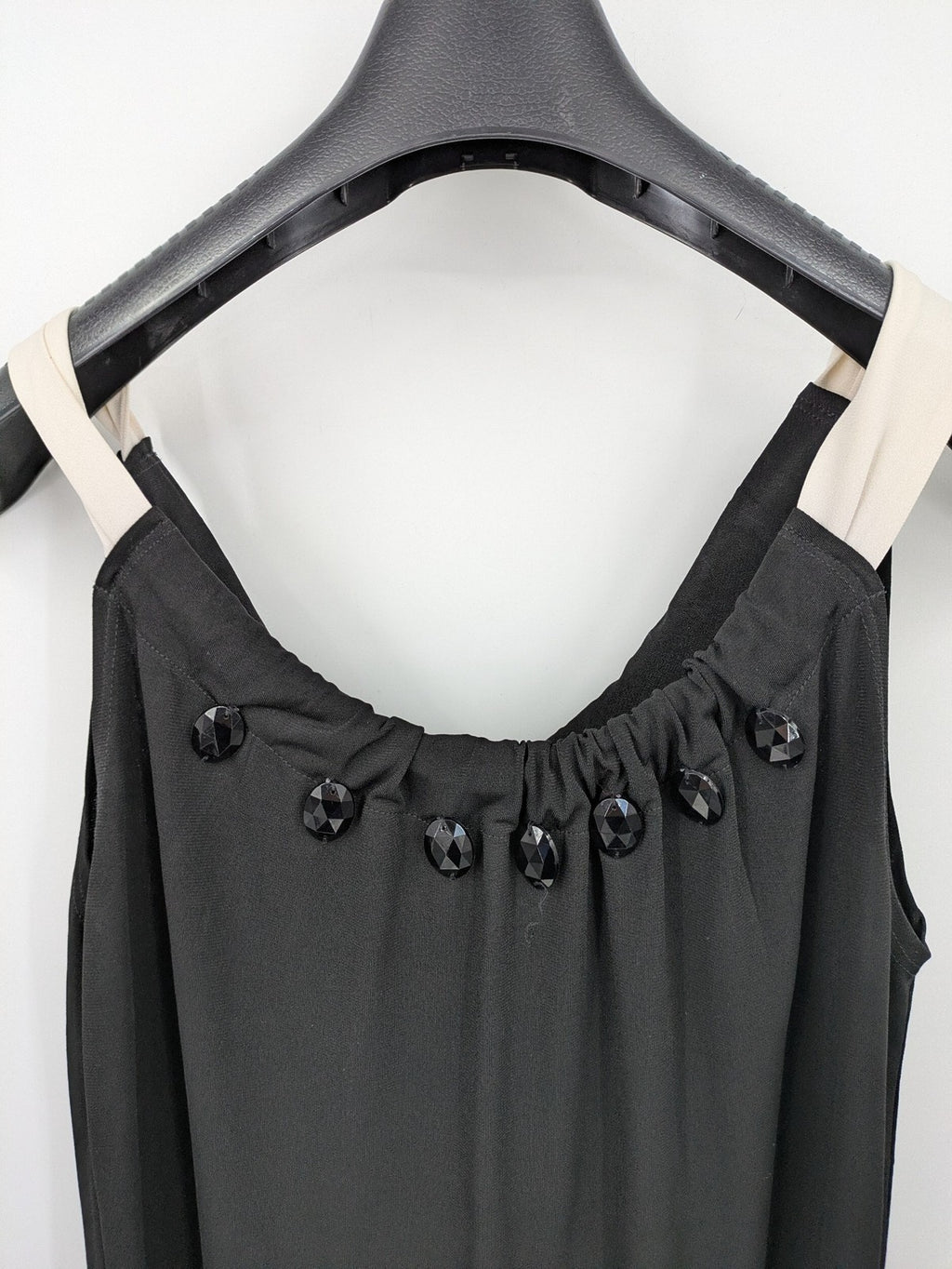 En Focus Studio beige and black top, sleeveless with beaded neckline and tie detail.