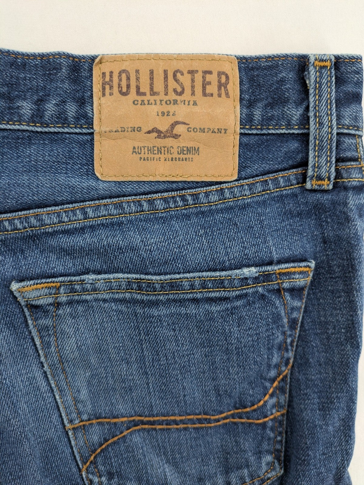 Hollister blue super skinny jeans medium wash button fly with faded details.