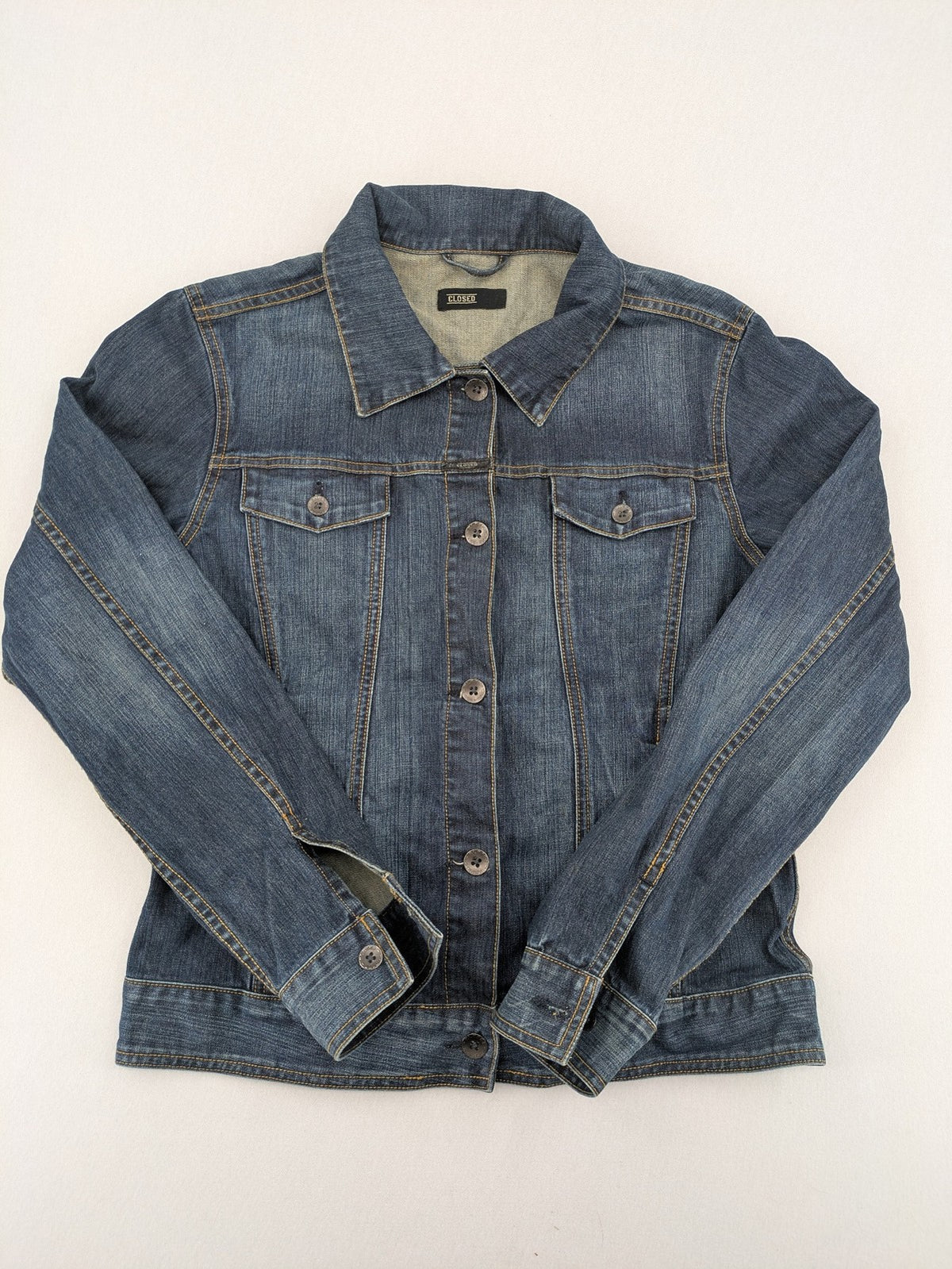 CLOSED blue denim trucker jacket with button front and two chest pockets.