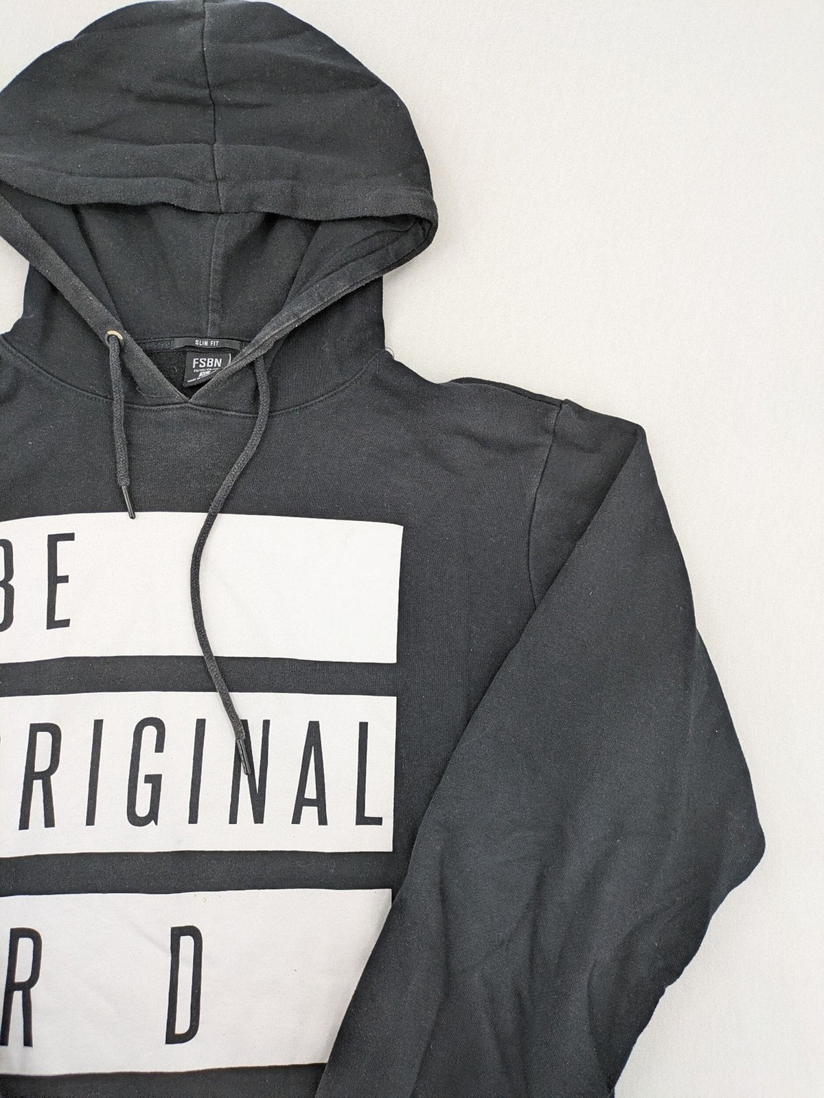 FSBN black hoodie with "BE ORIGINAL OR DIE" graphic print, slim fit, cotton-polyester blend.