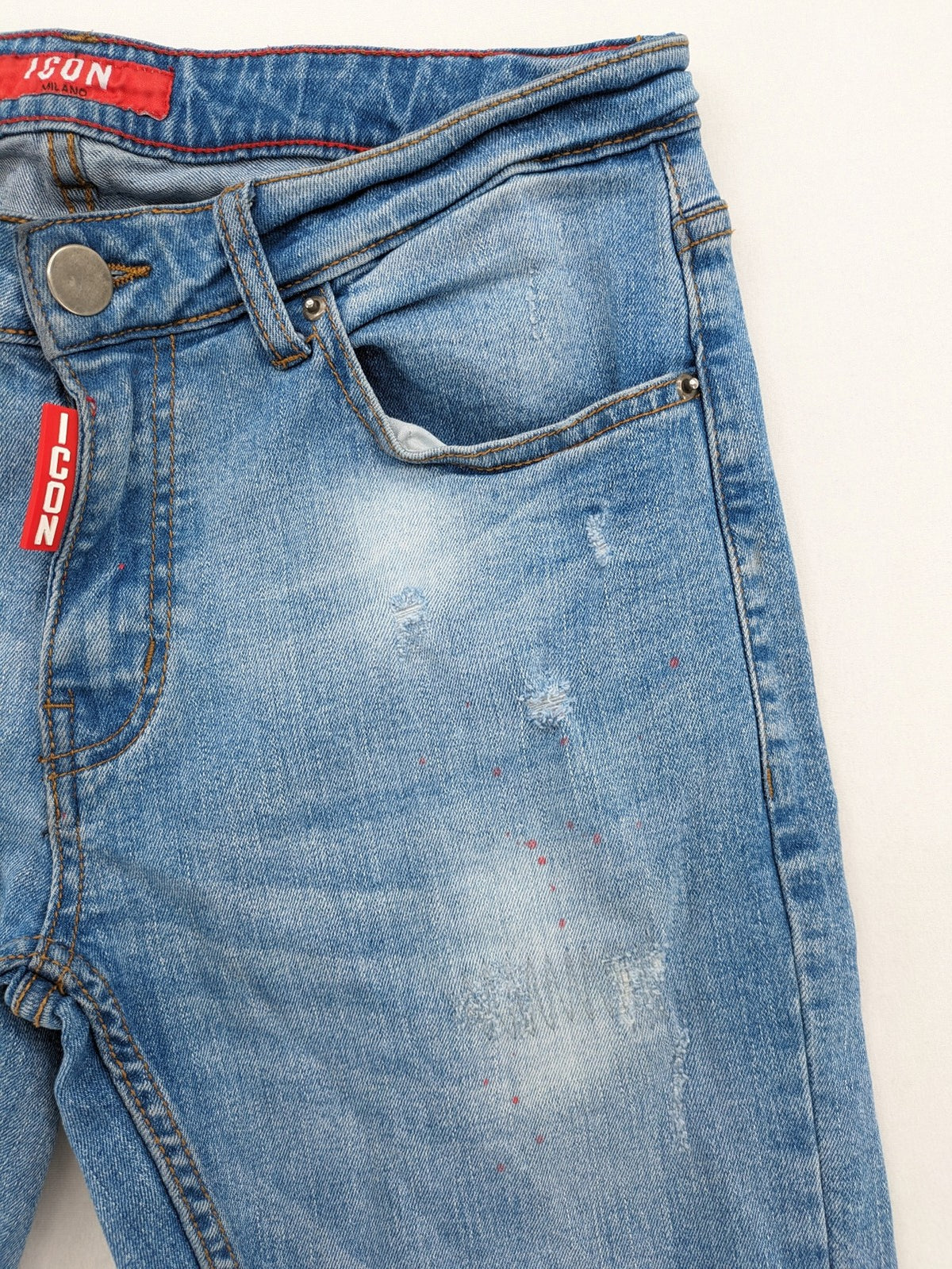 Milano straight jeans light blue distressed with red splatter and extra slim fit.