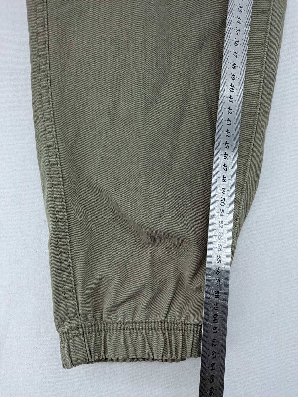 Y.F.K. khaki cargo pants with elastic cuffs, side pockets, and drawstring waistband.