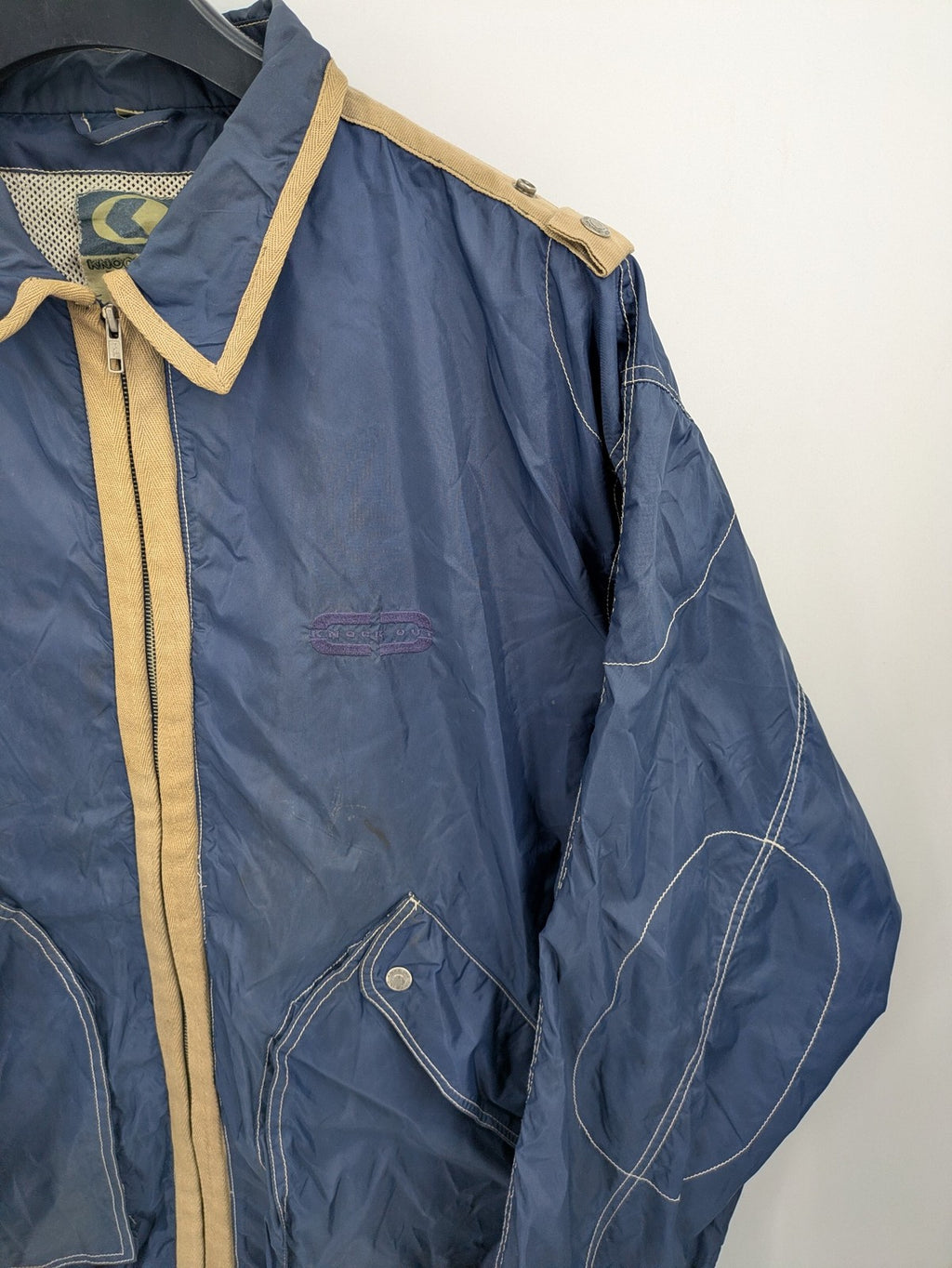 Knock Out navy blue jacket full zip nylon with brown accents and breathable mesh lining.