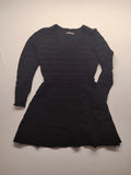 Supertuga black ribbed dress with V-neck, long sleeves, and pointelle detail at waist.