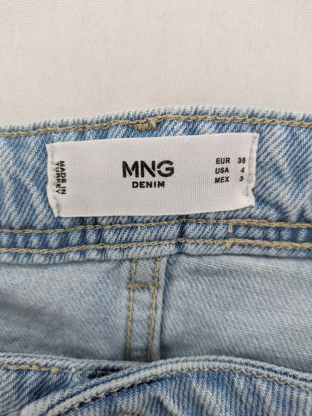 MNG blue straight jeans with cargo pockets and raw hem, high waist denim.