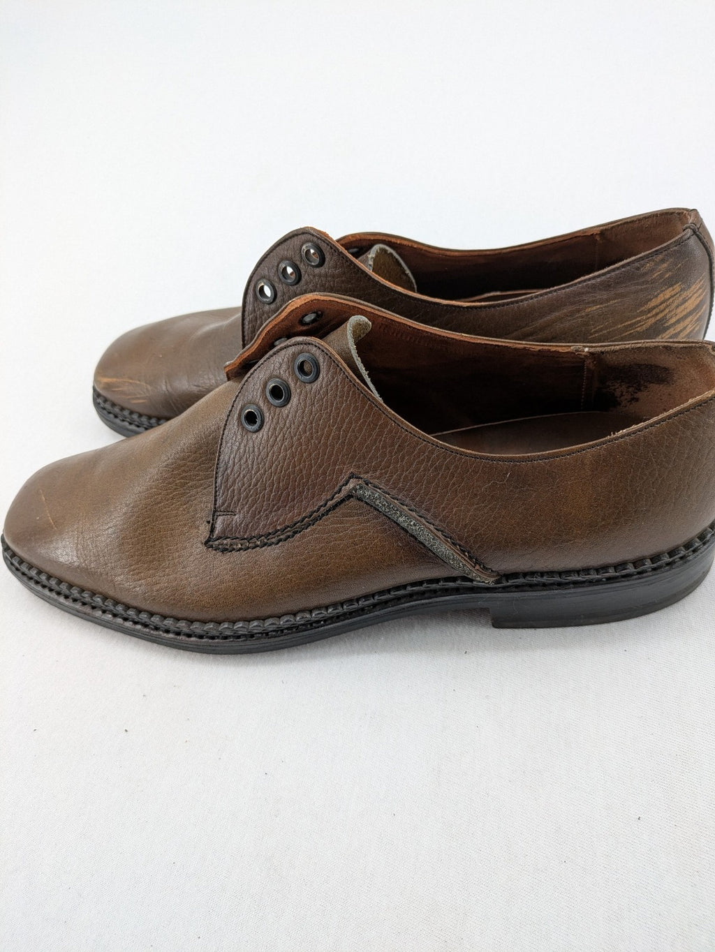 Fonda brown deck shoes genuine leather square toe design with decorative stitching.