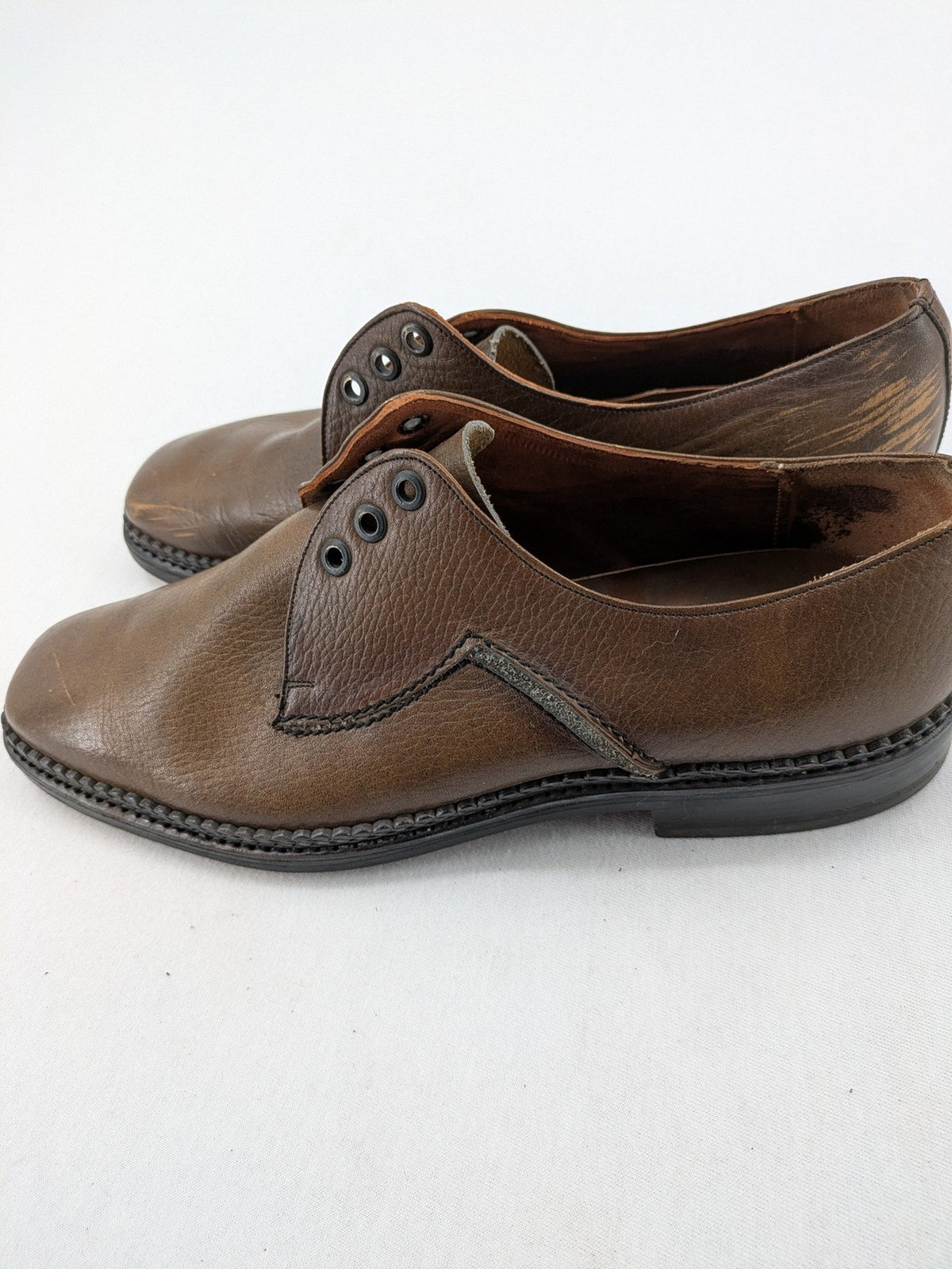 Fonda brown deck shoes genuine leather square toe design with decorative stitching.
