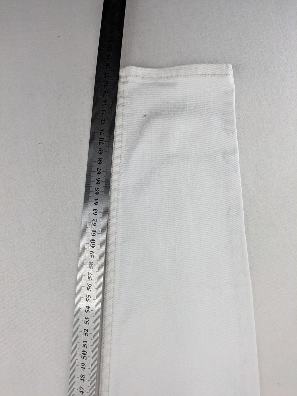 Hollister white super skinny high rise jeans with classic 5-pocket design and zipper closure.