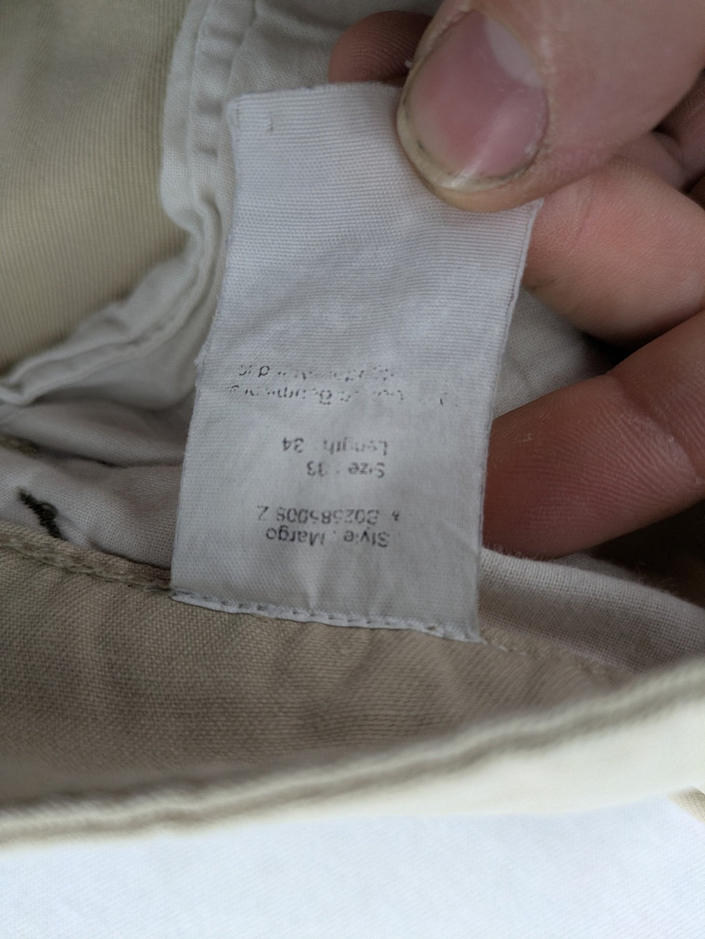 Cottonfield beige cargo pants with multiple pockets and button flaps.