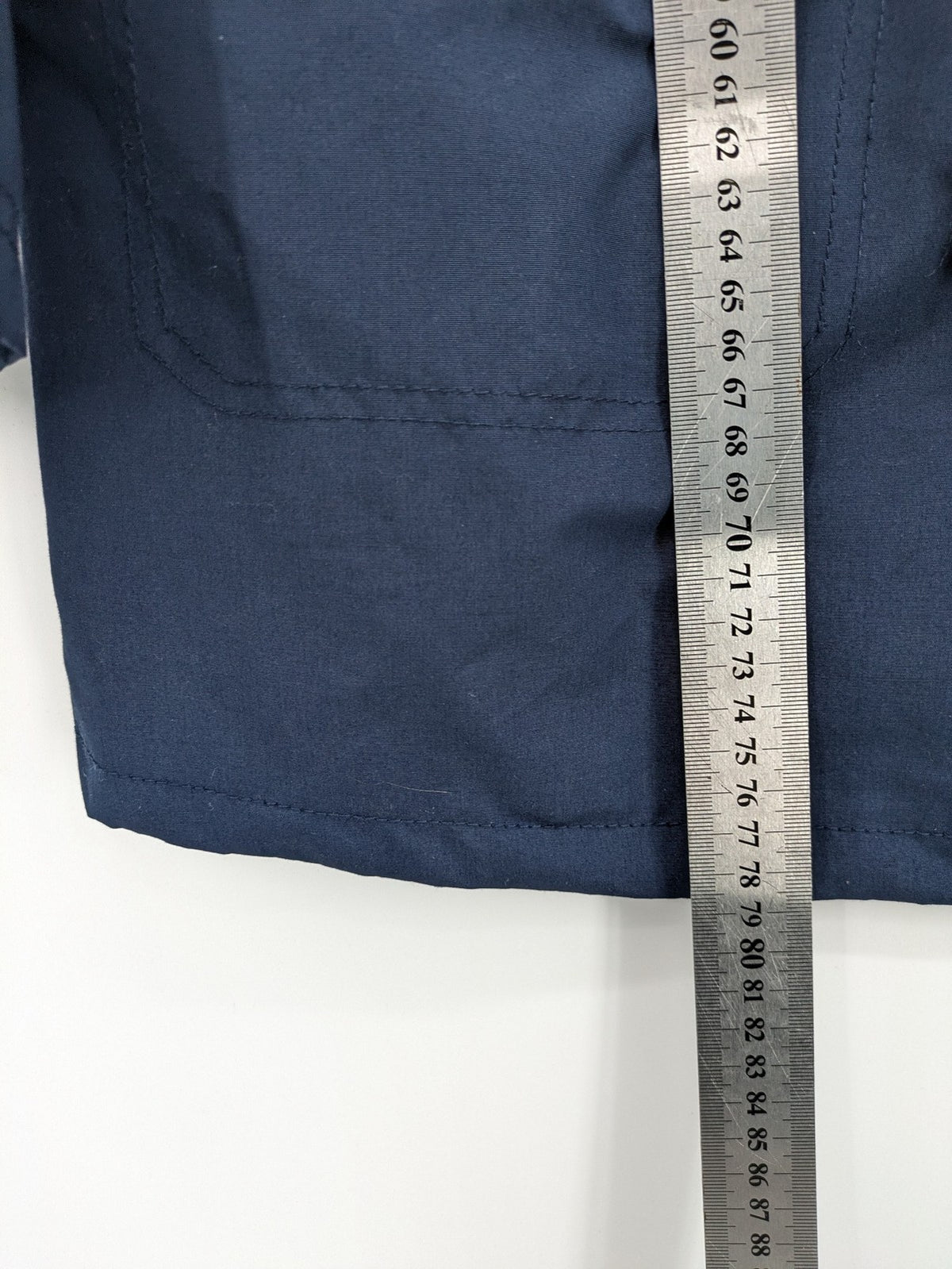 Janina navy anorak jacket with high collar and adjustable drawstring waist.