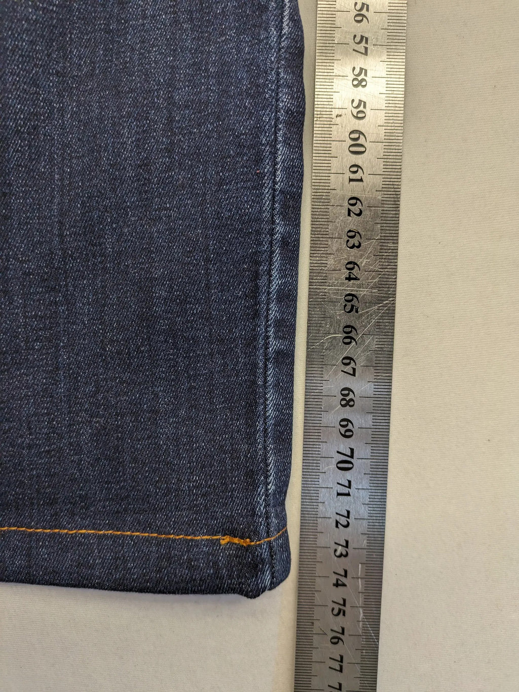 Diesel blue straight jeans with regular waist, dark wash, and stretch material.