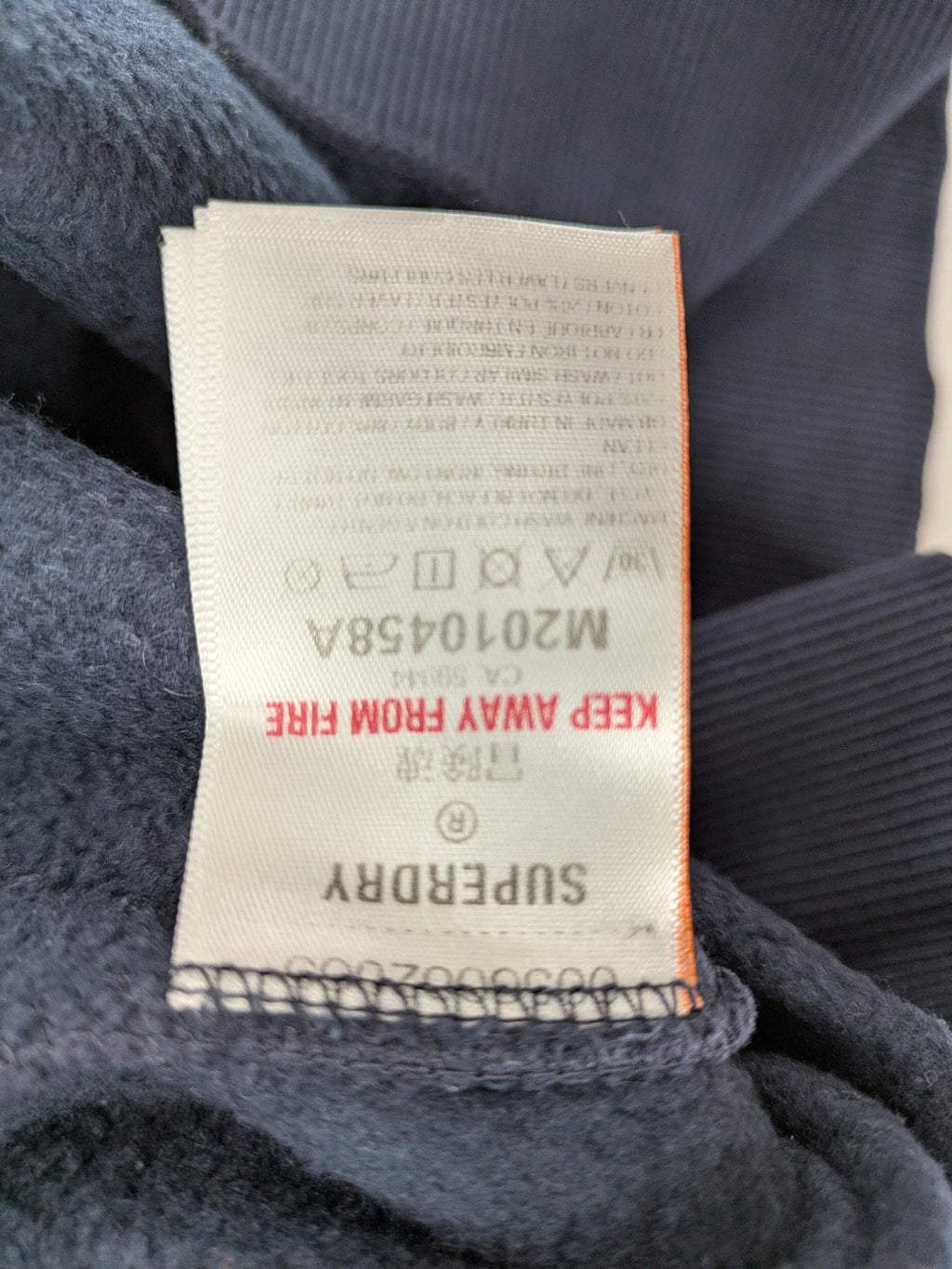 Superdry navy sweatshirt with embroidered tiger graphic and "JPN 54" chenille detail.