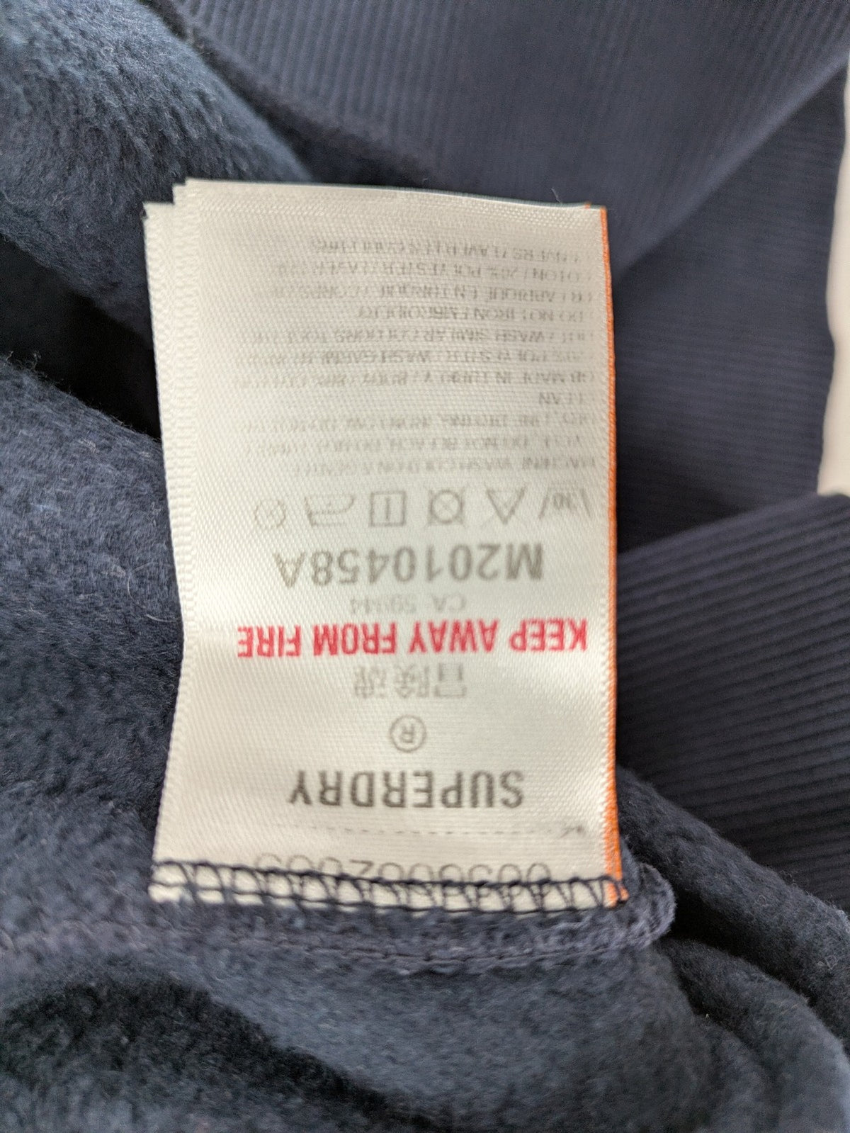 Superdry navy sweatshirt with embroidered tiger graphic and "JPN 54" chenille detail.