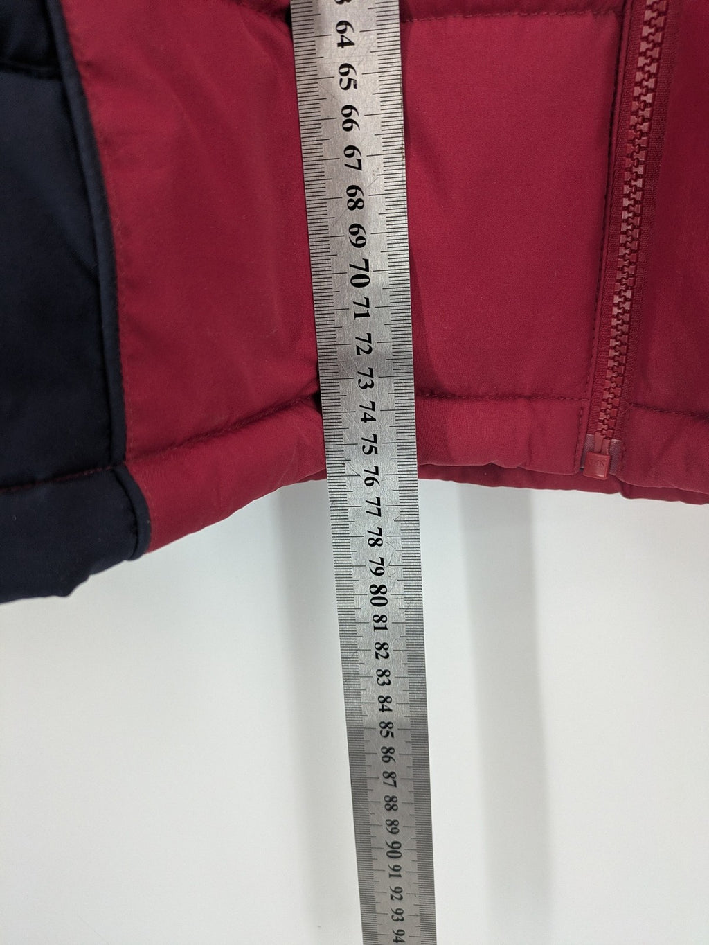 US Polo Assn. puffer jacket navy red two-tone design with embroidered logo and zip pockets.
