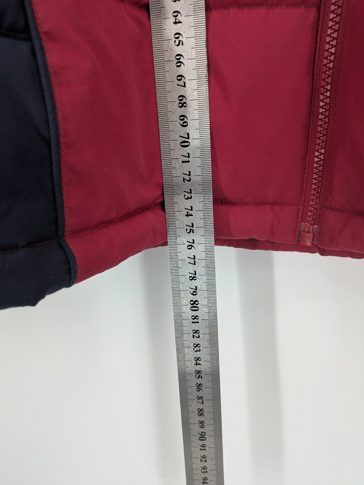 US Polo Assn. puffer jacket navy red two-tone design with embroidered logo and zip pockets.