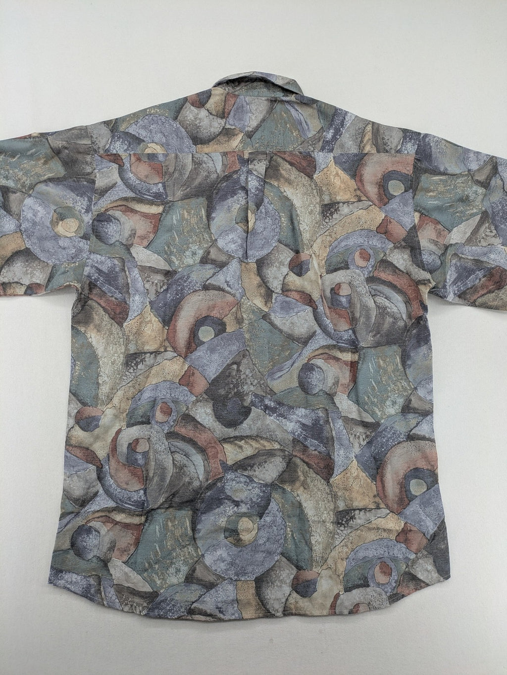 Club D'Amingo short sleeve shirt multi abstract geometric pattern in earthy tones.