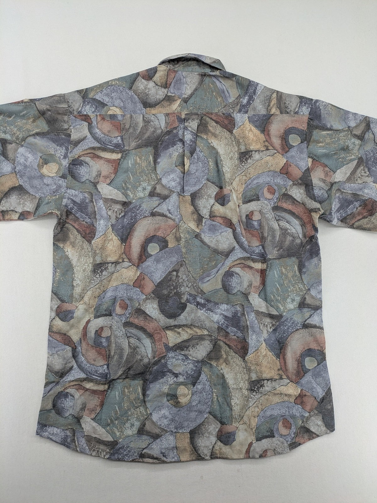 Club D'Amingo short sleeve shirt multi abstract geometric pattern in earthy tones.