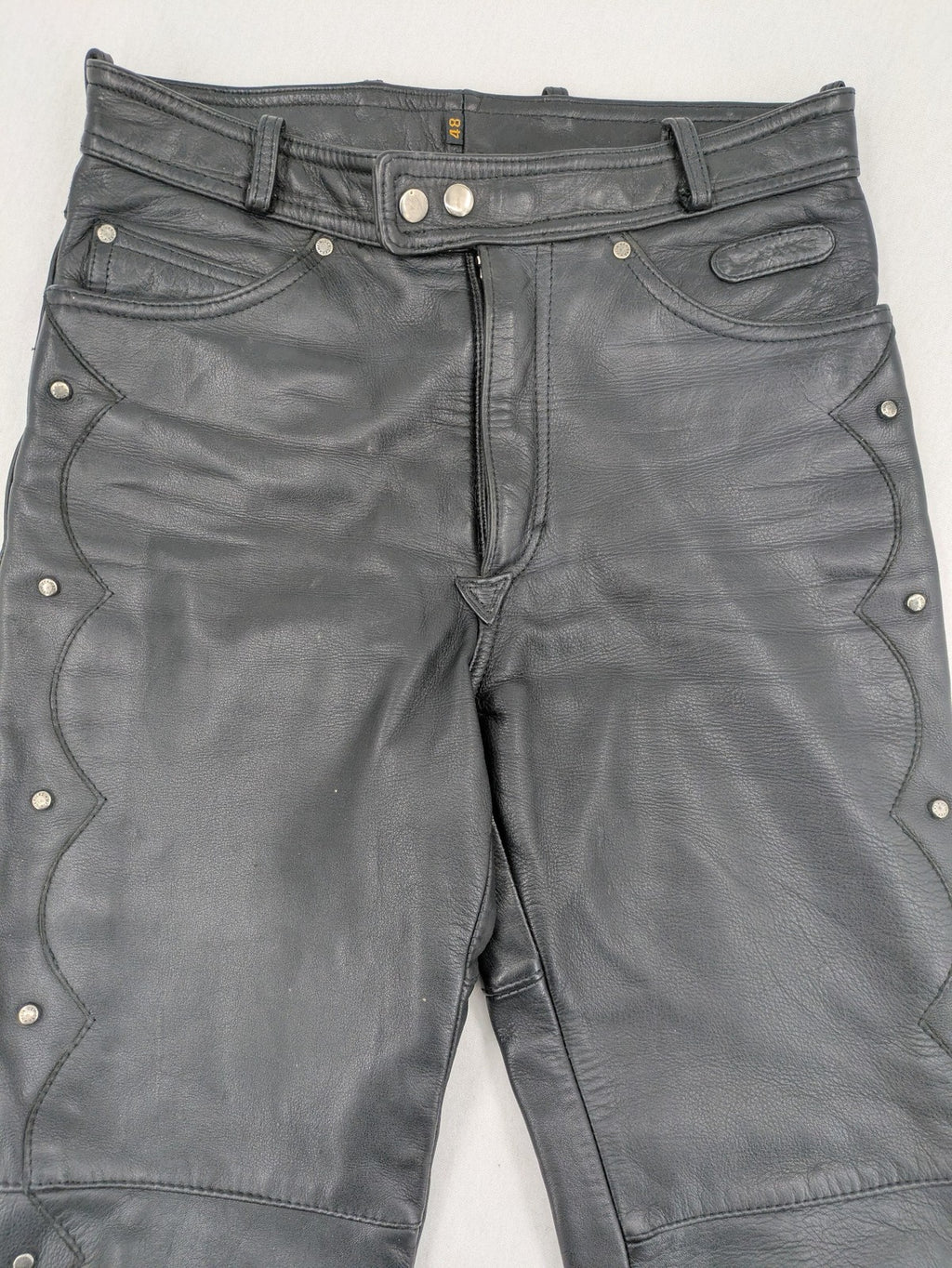 Hein Gericke black leather chaps with studs and wavy decorative seams.