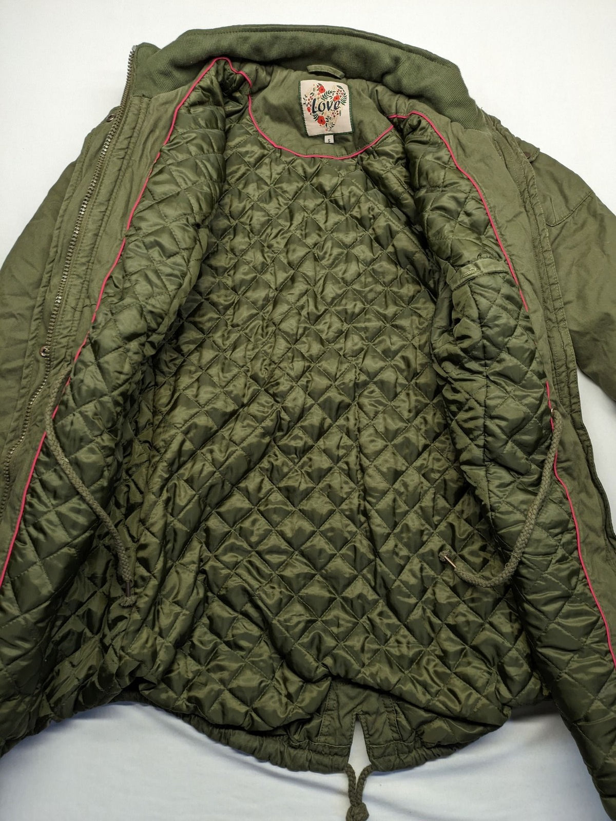 Vp Fashion khaki parka coat with "Bloomin' Lovely" floral embroidery and quilted lining.