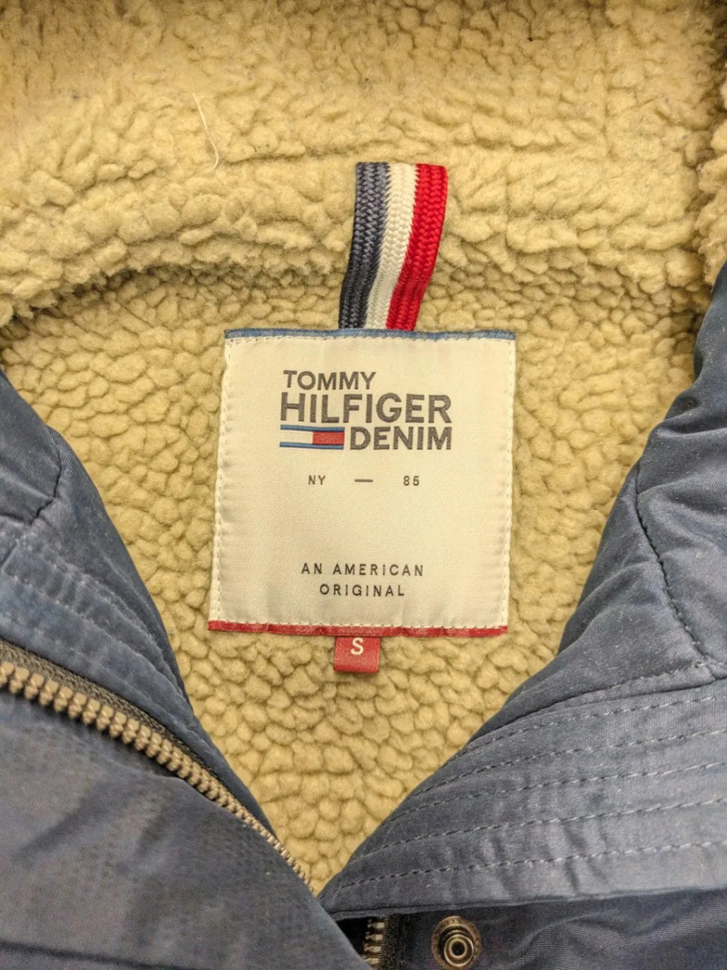 Tommy Hilfiger Denim blue parka coat with faux fur hood and Sherpa lining.