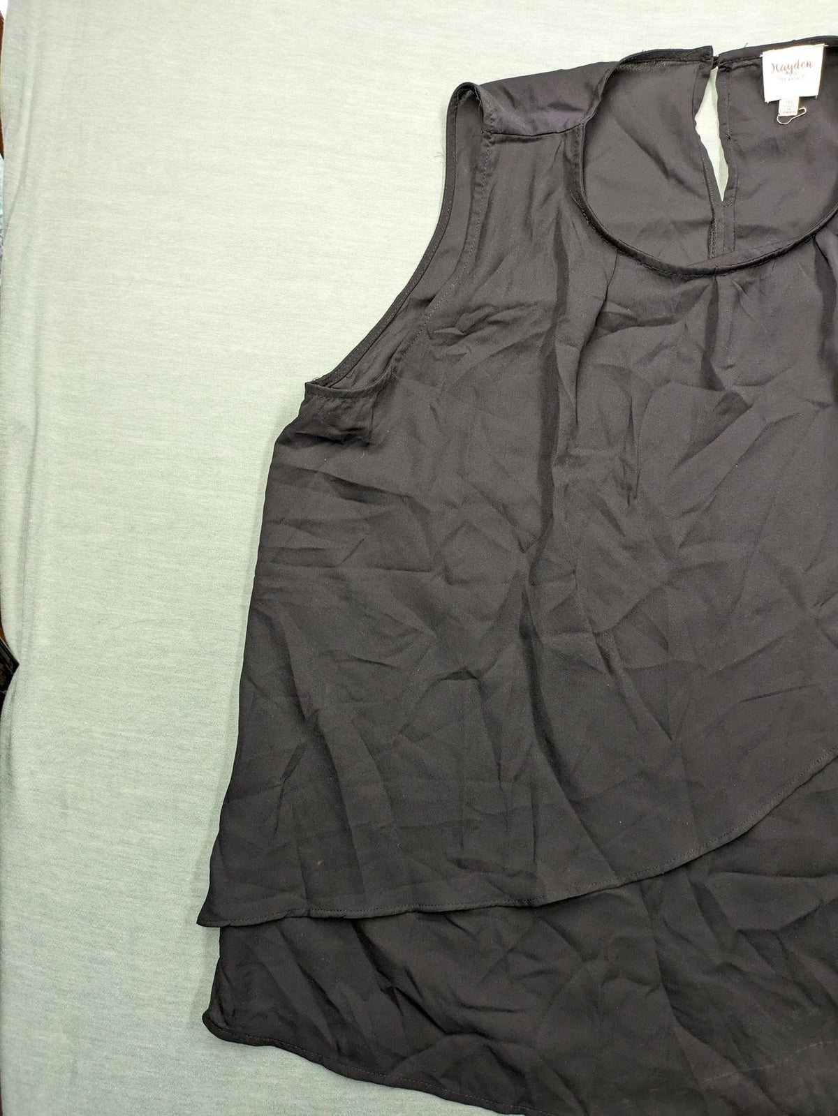 Hayden pink top asymmetrical layered design with ruffle detail, made of 100% polyester.