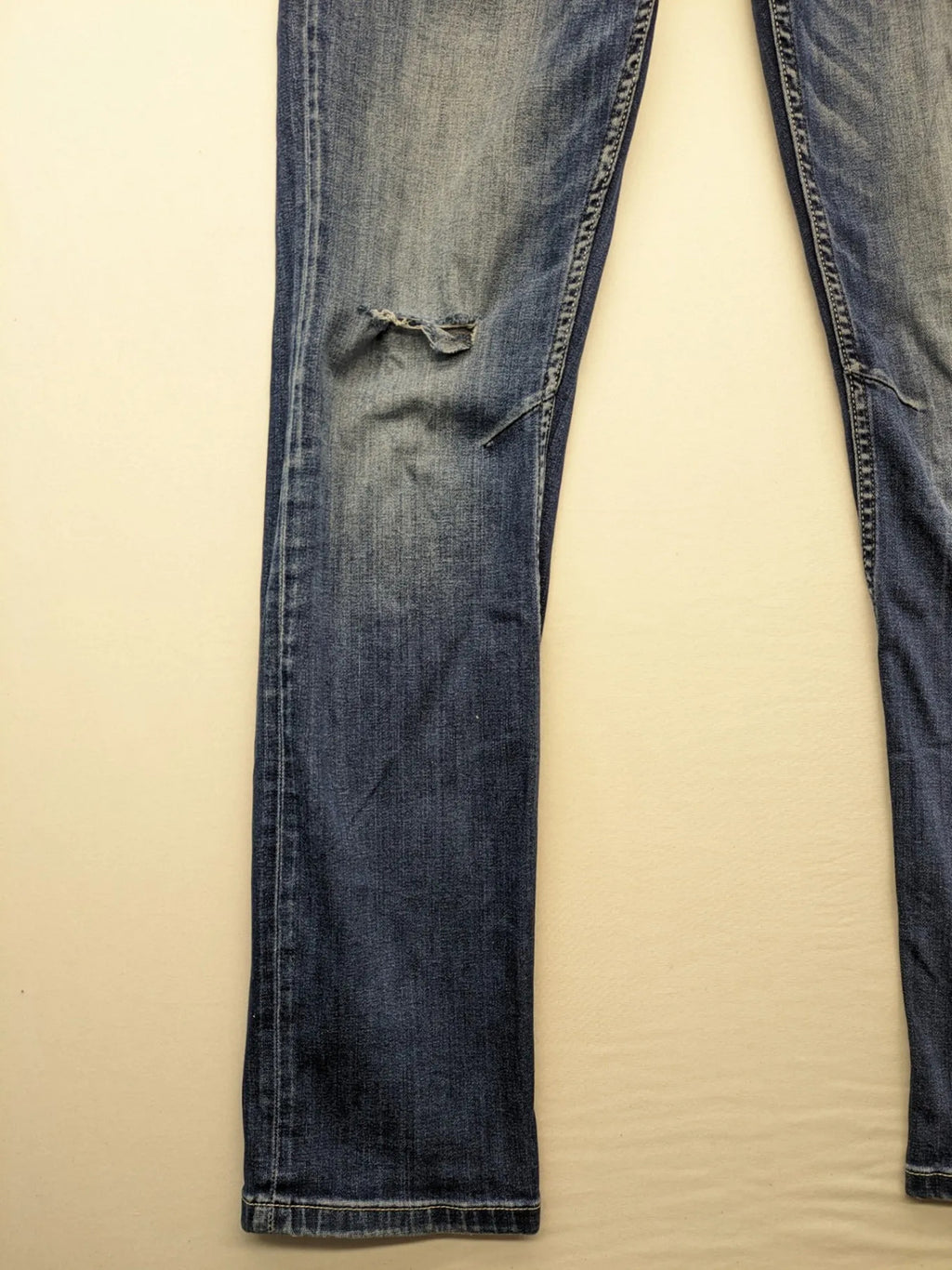 WAM Denim blue straight jeans with distressed details and button fly.
