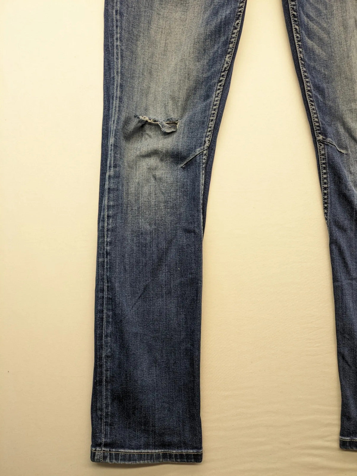 WAM Denim blue straight jeans with distressed details and button fly.