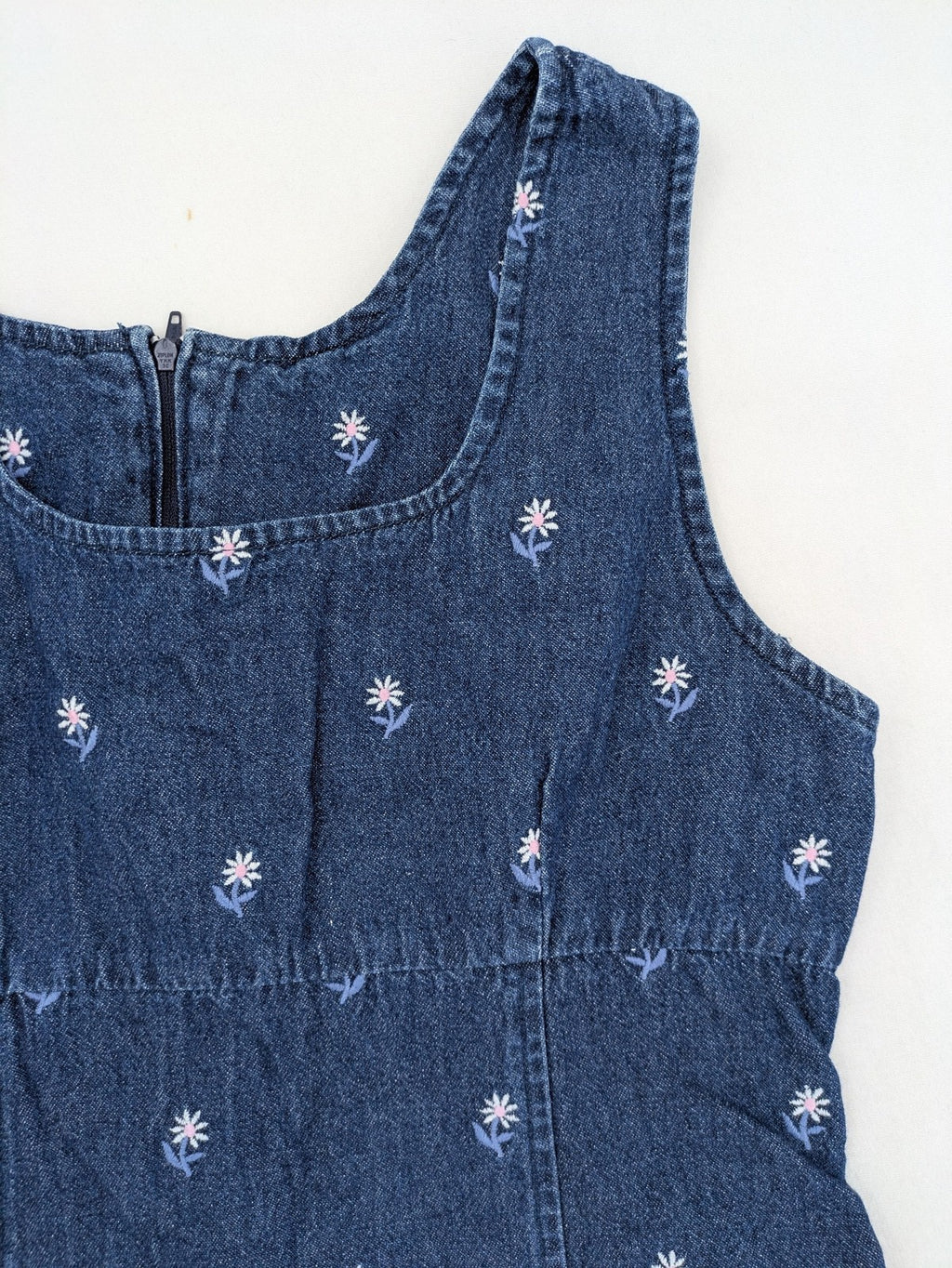 Damen blue denim mini dress with all-over white and light blue floral embroidery.