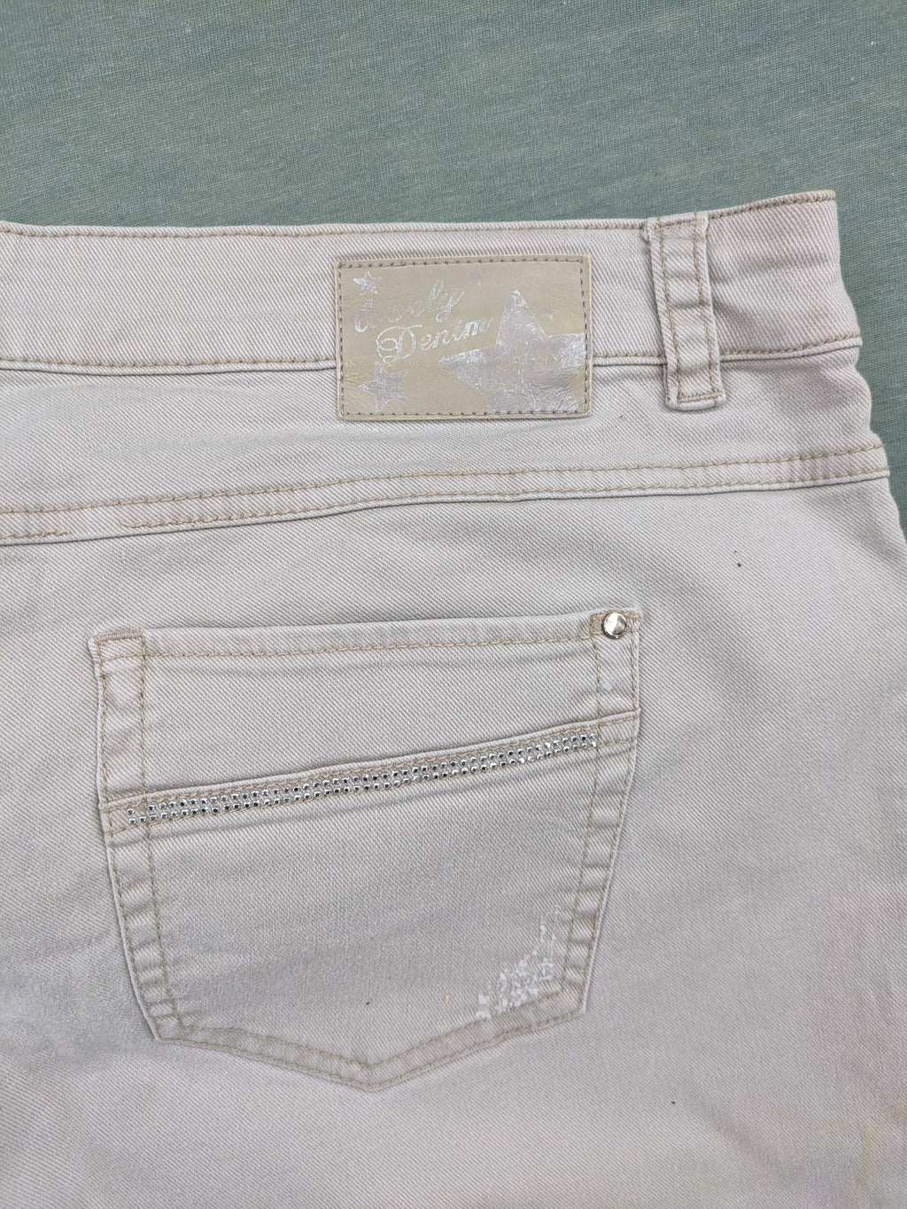 Canda beige straight jeans with strass details and classic five-pocket design.