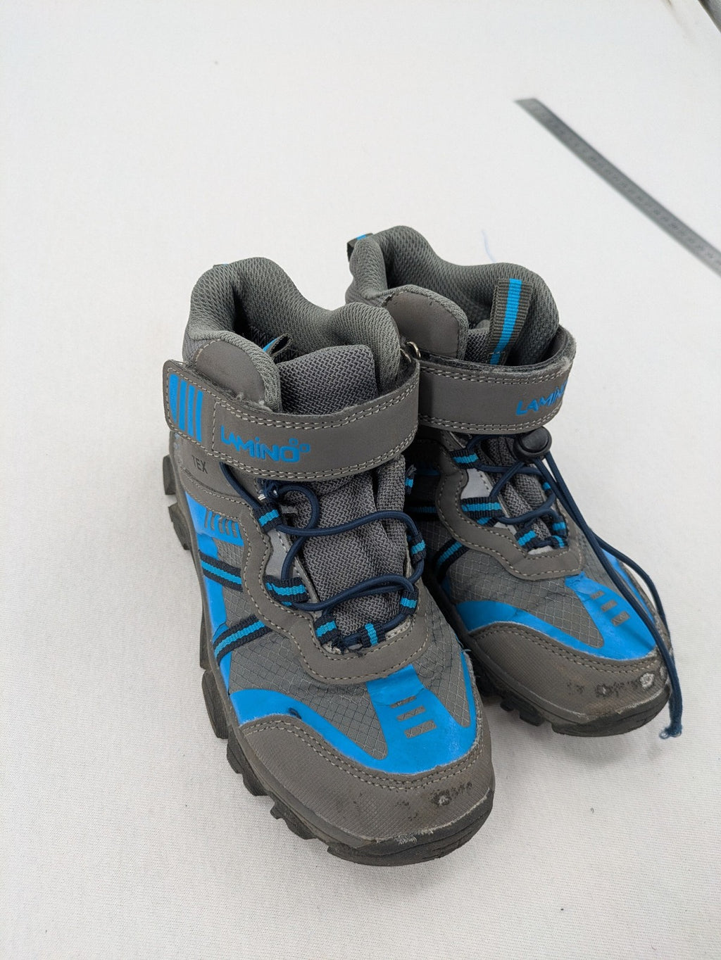 Outdoor grey and blue winter boots with high shaft, Velcro closure, and textured sole.