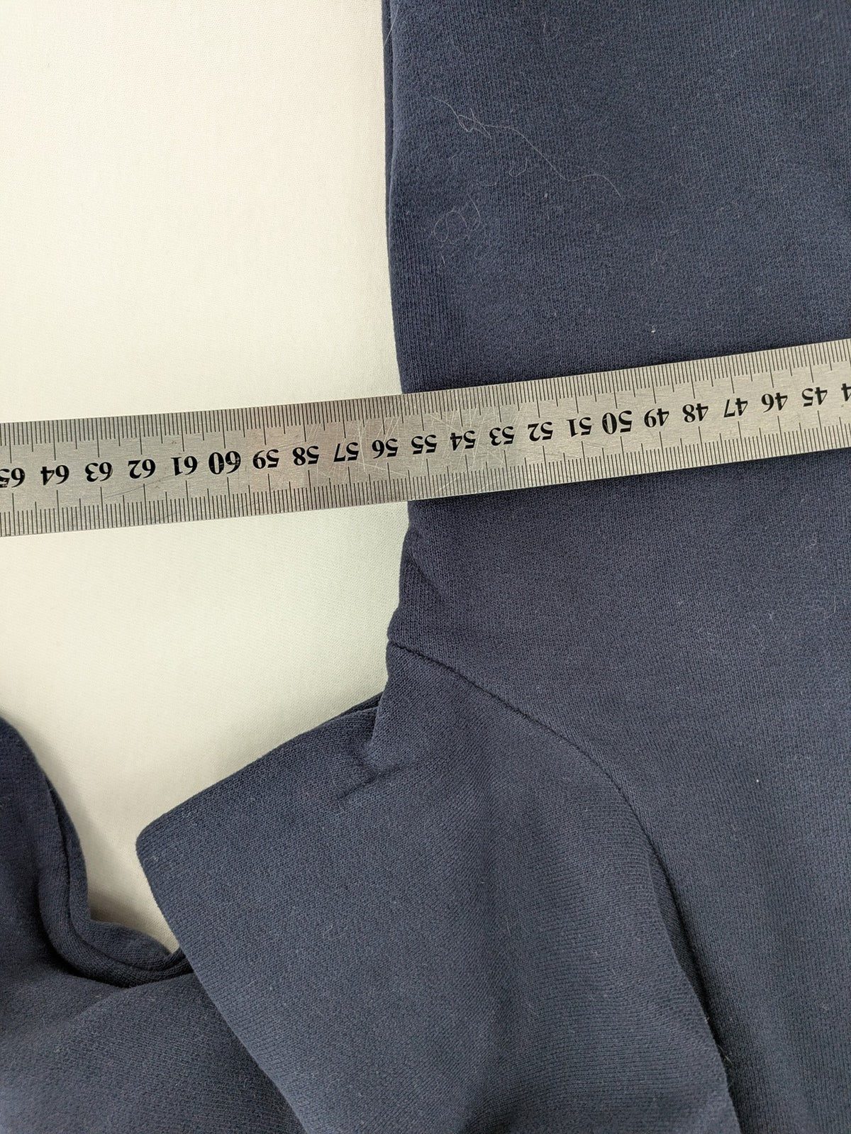 Superdry navy sweatshirt with embroidered tiger graphic and "JPN 54" chenille detail.