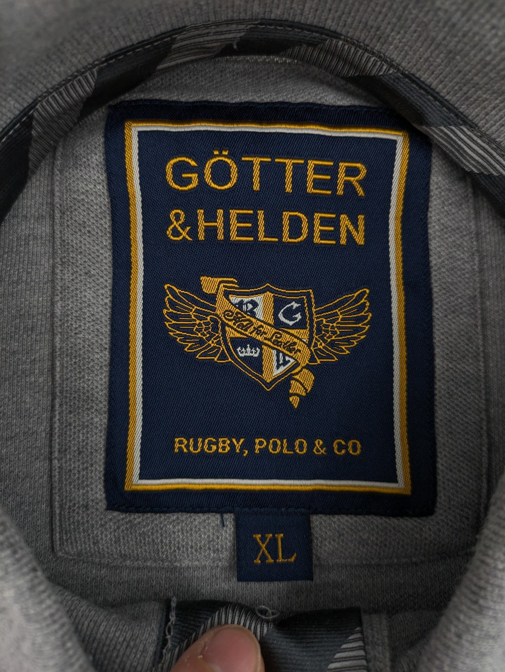 Götter & Helden grey polo shirt with "Gods Favorite" embroidery and contrasting collar details.
